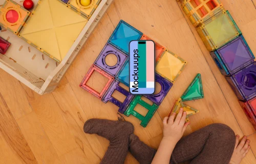Smartphone mockup with colorful toy blocks and child's hands