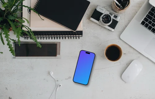 Smartphone mockup with headphones and MacBook Pro