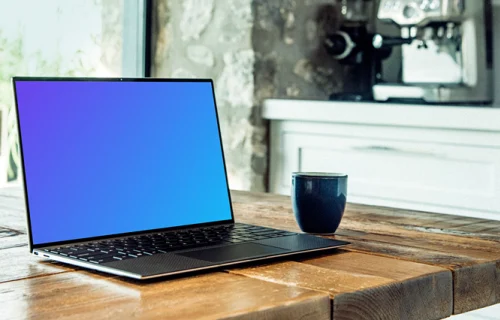 Dell XPS mockup on table with coffee mug at the side