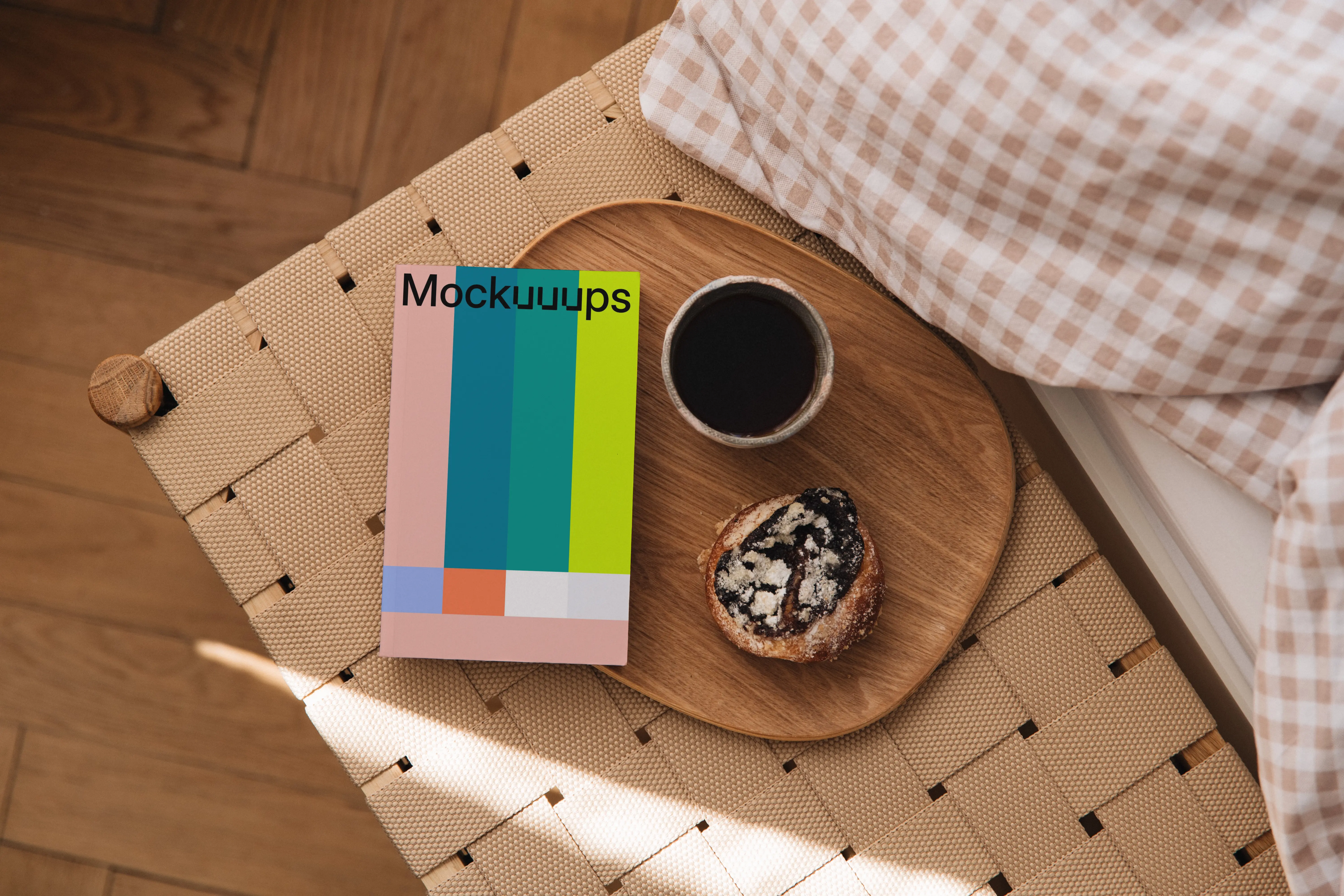 Softcover book mockup on a wooden tray with coffee and pastry mockup