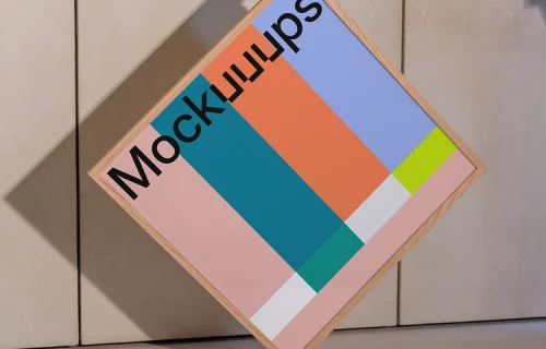 Square wooden frame mockup held against a textured wall