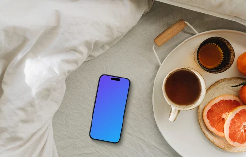 Sun-kissed breakfast scene including an iPhone mockup