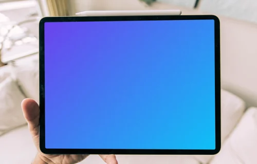 Tablet mockup held by a user over a couch