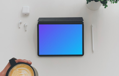Tablet mockup on a white table with Airpods at the side
