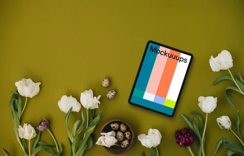 Tablet mockup with tulips on green background