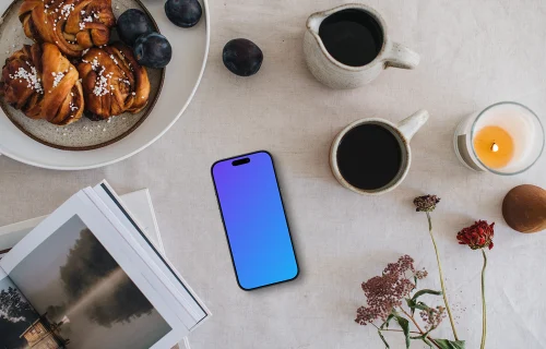 Top view of phone mockup next to the coffee