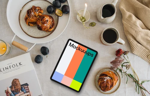 Top view of tablet mockup next to the magazine