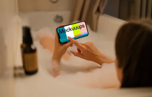 Woman hand typing on an iPhone 13 mockup