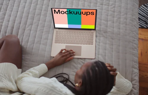 Woman working on the Microsoft Surface Laptop mockup from bed