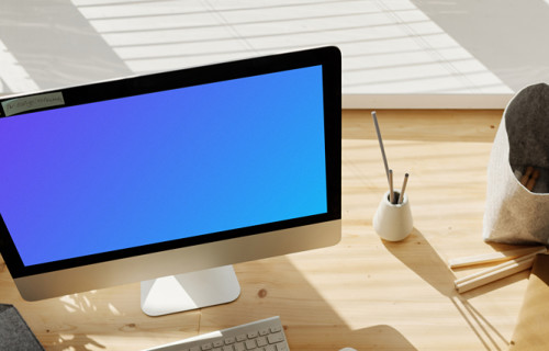 Young girl writing into her book from an iMac mockup