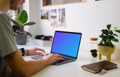 Young man working on the Macbook Pro mockup