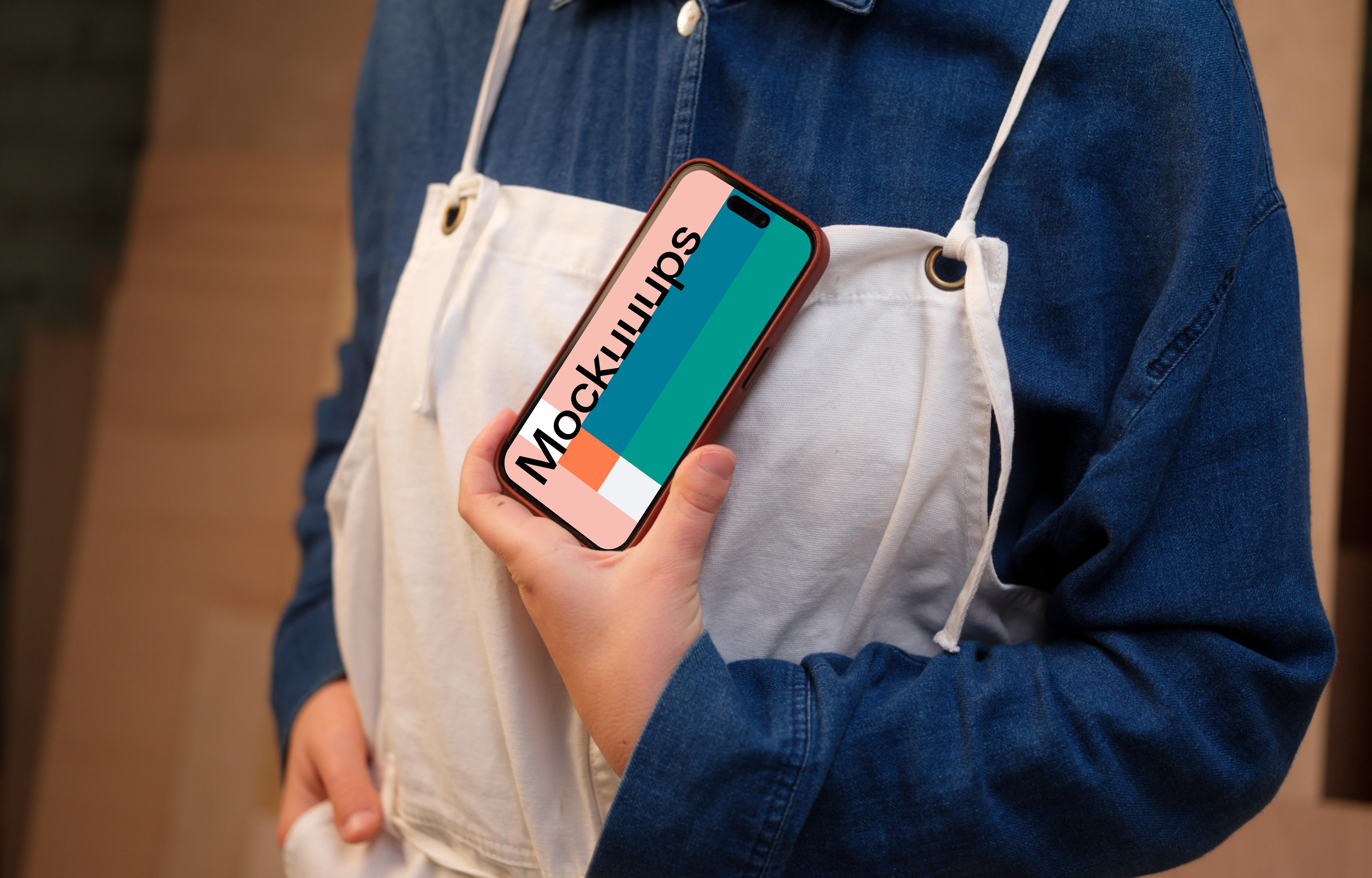 Crafter holding an iPhone mockup in the workshop