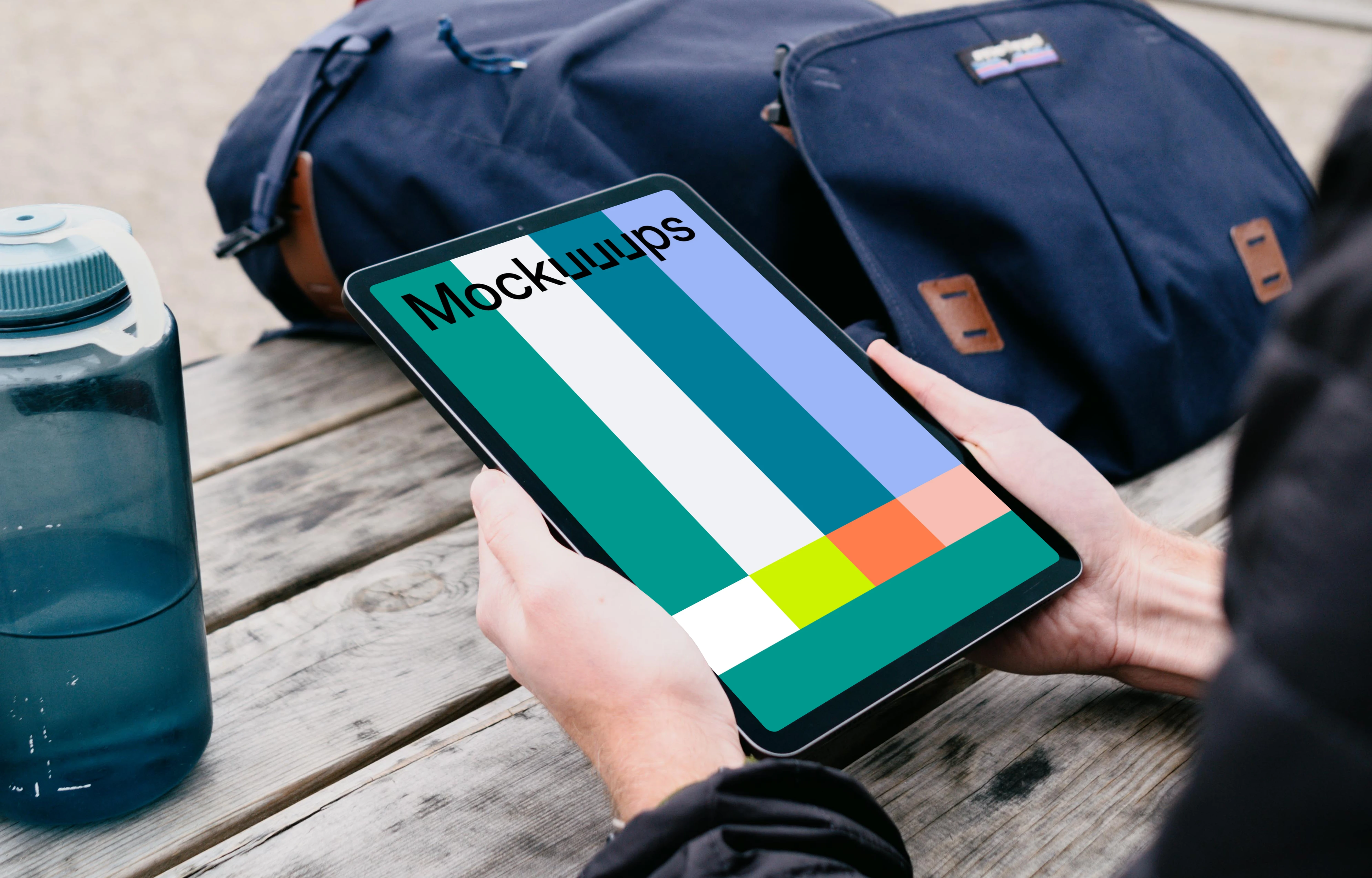 iPad Air mockup in a user’s hand in a park