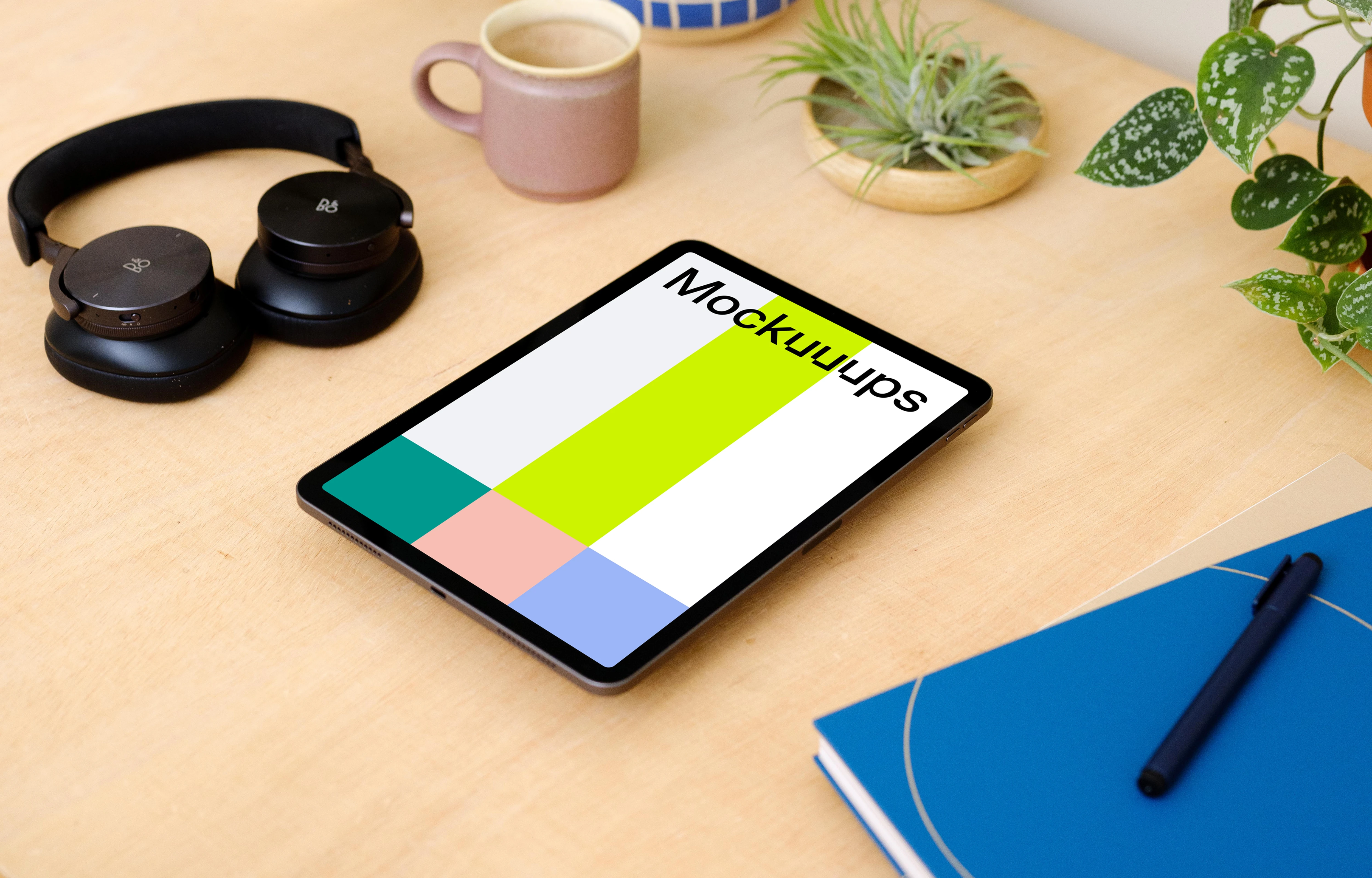 iPad Air mockup on a table surrounded with potted plants