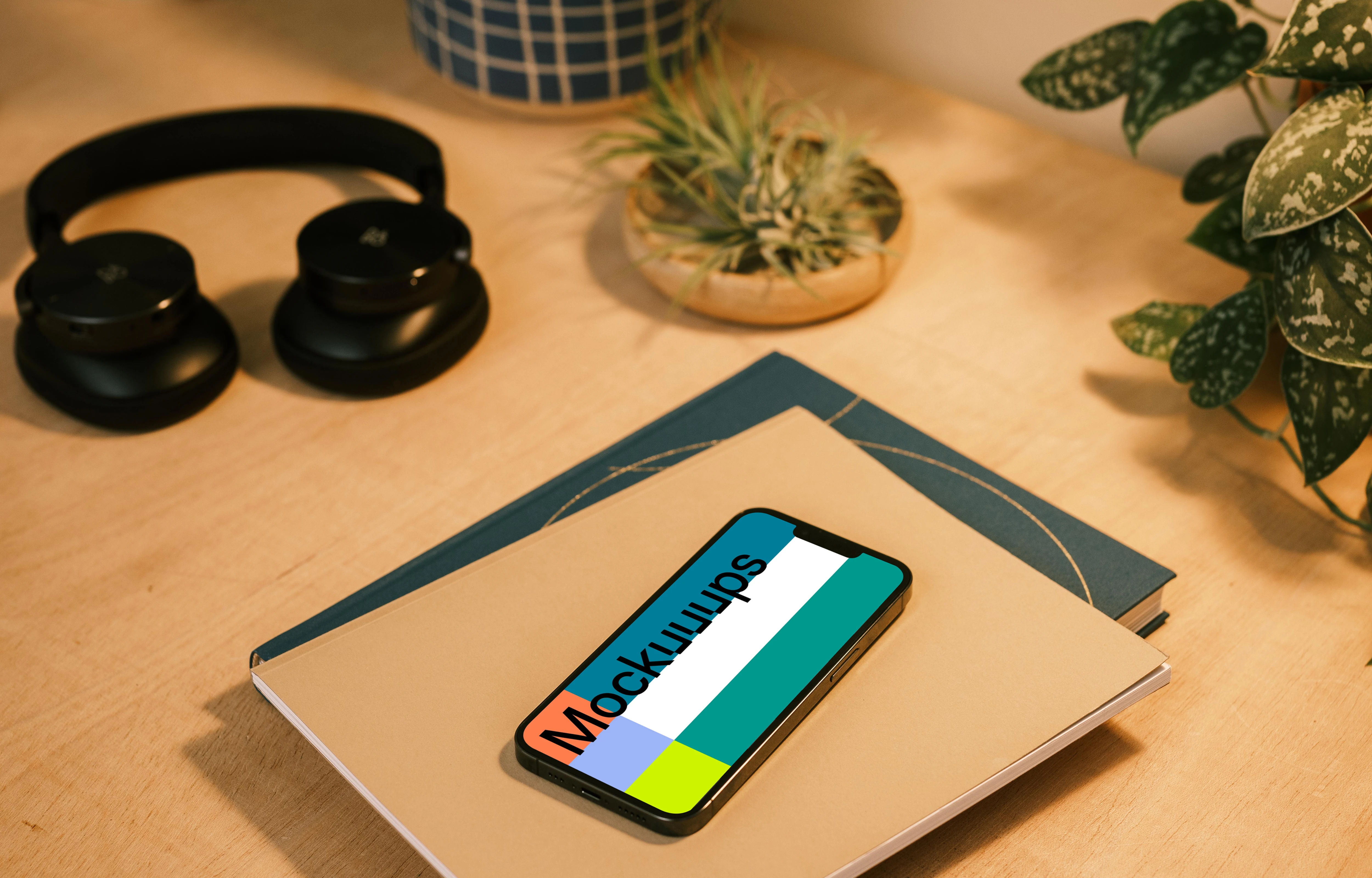 iPhone 13 Pro mockup on a stack of notebooks