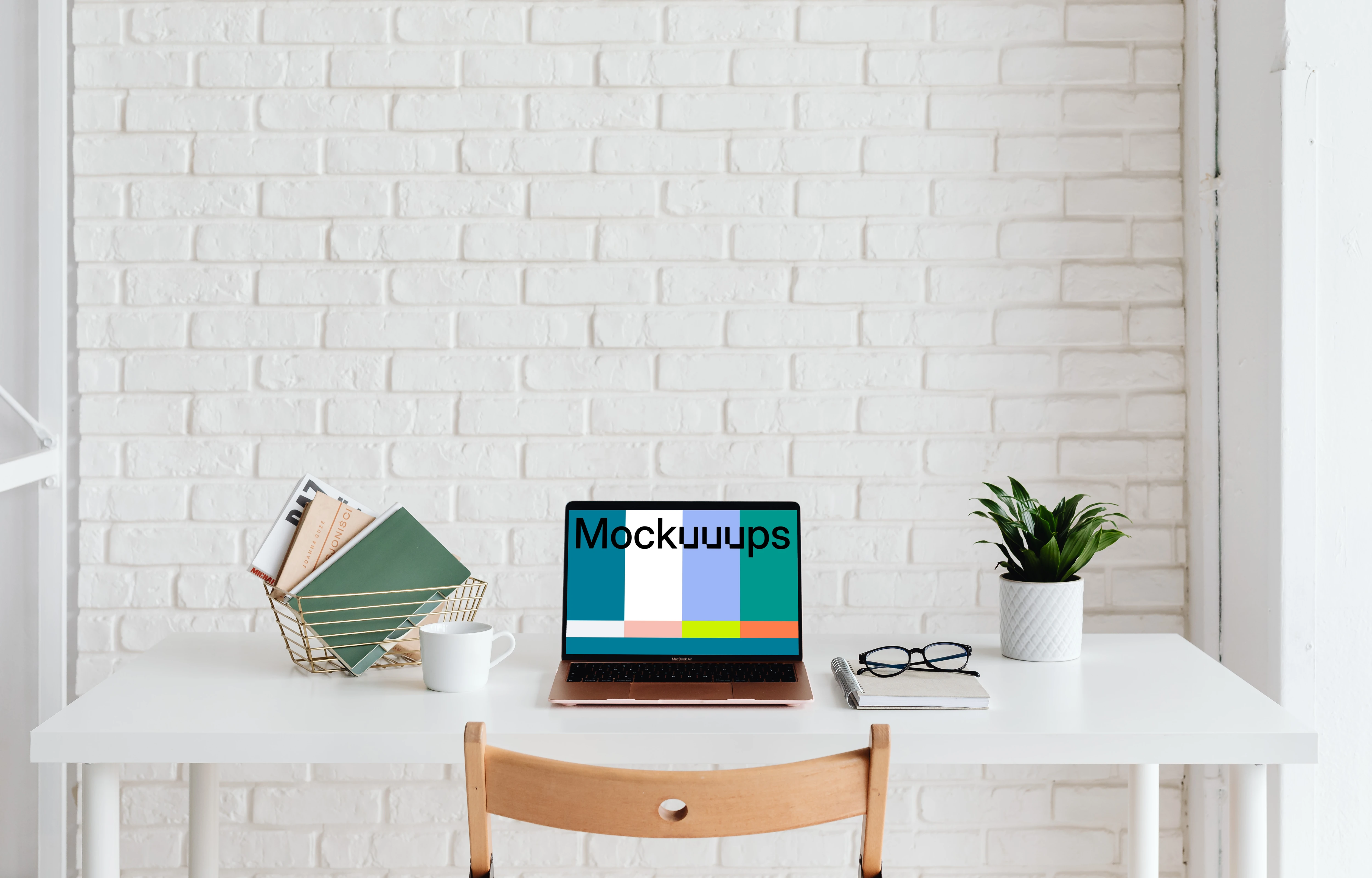 MacBook Air mockup beside a basket of books