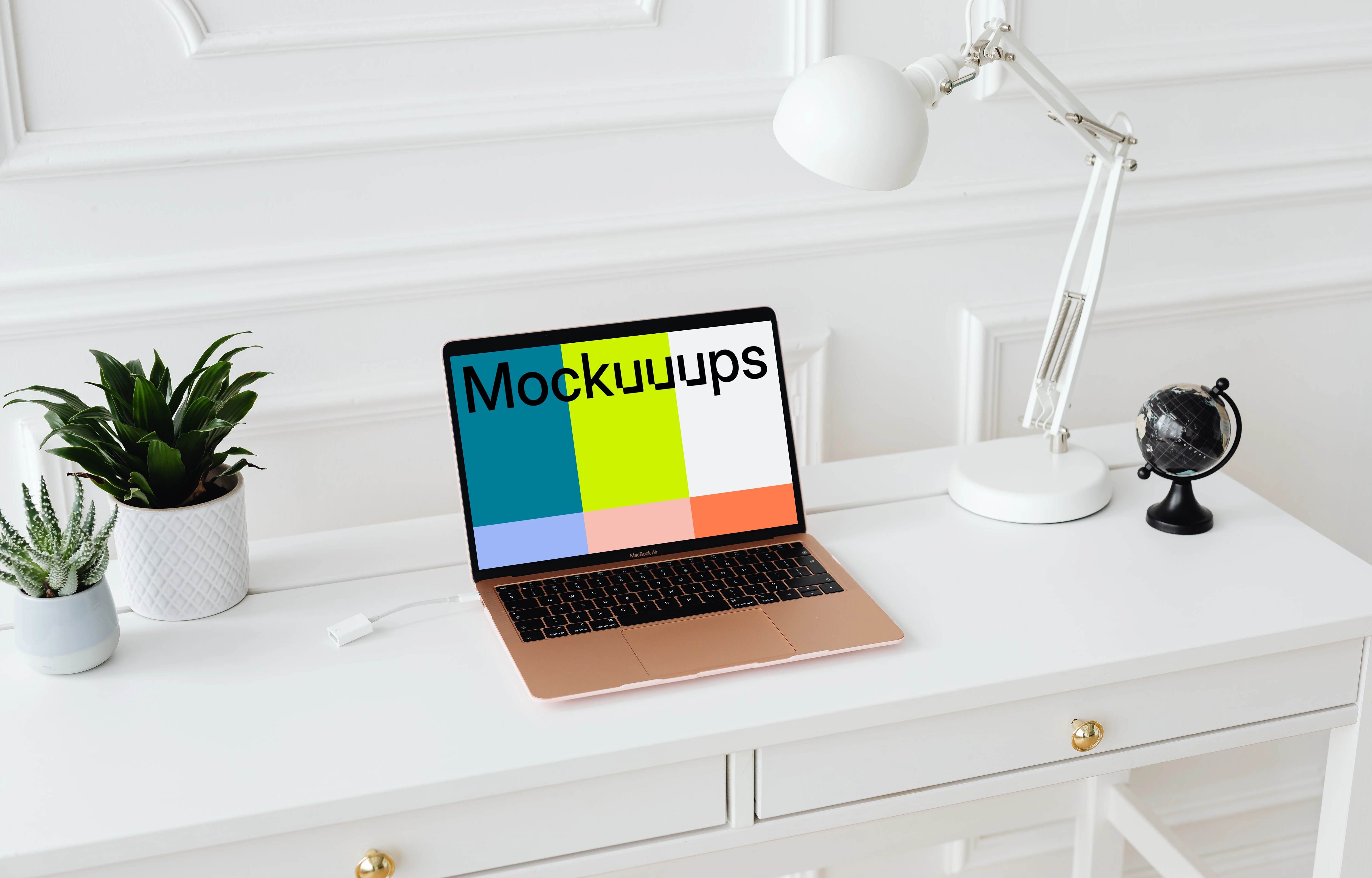 MacBook Air mockup on a table with a globe at the side