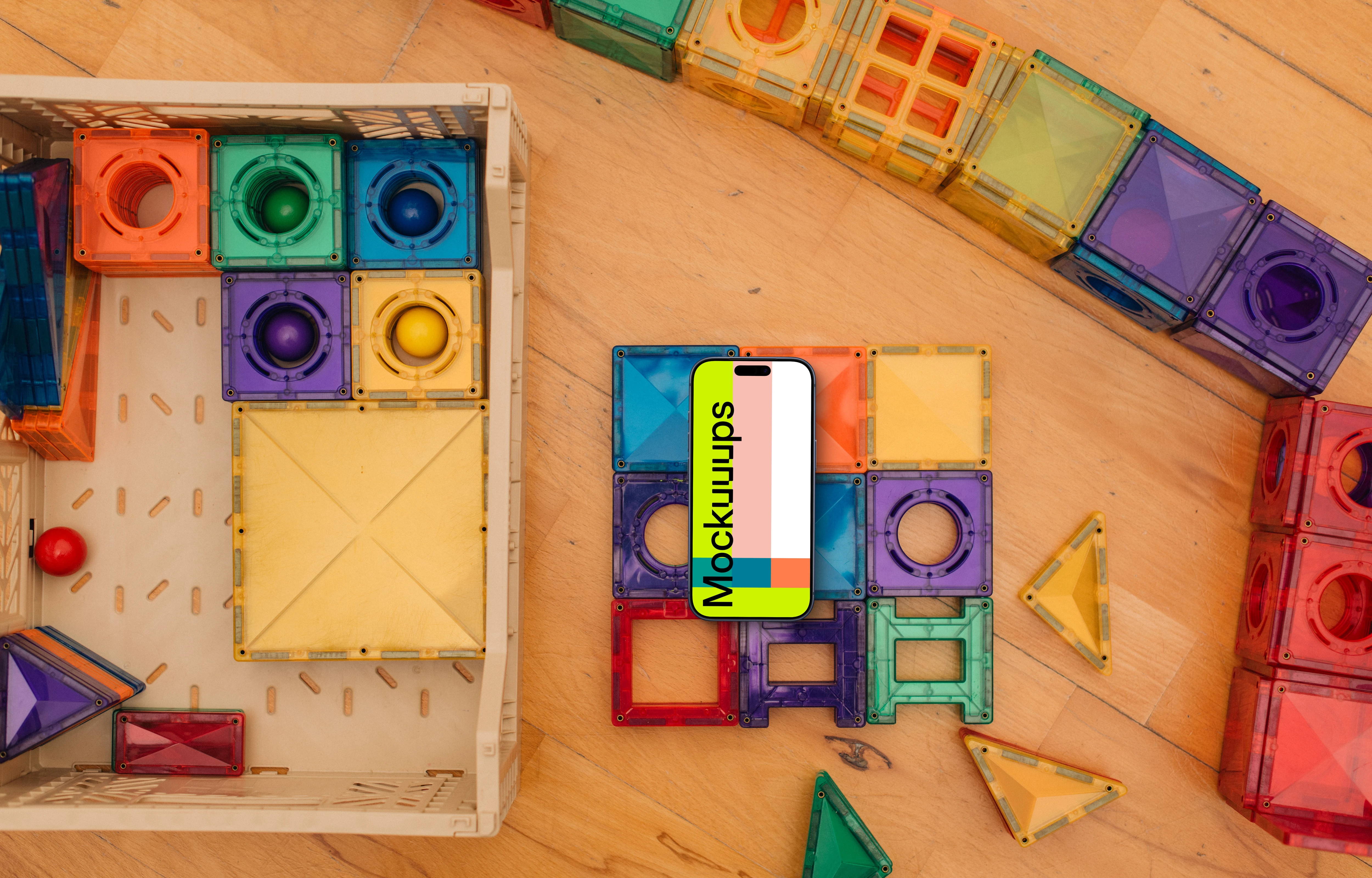 Smartphone mockup amidst colorful children's toys