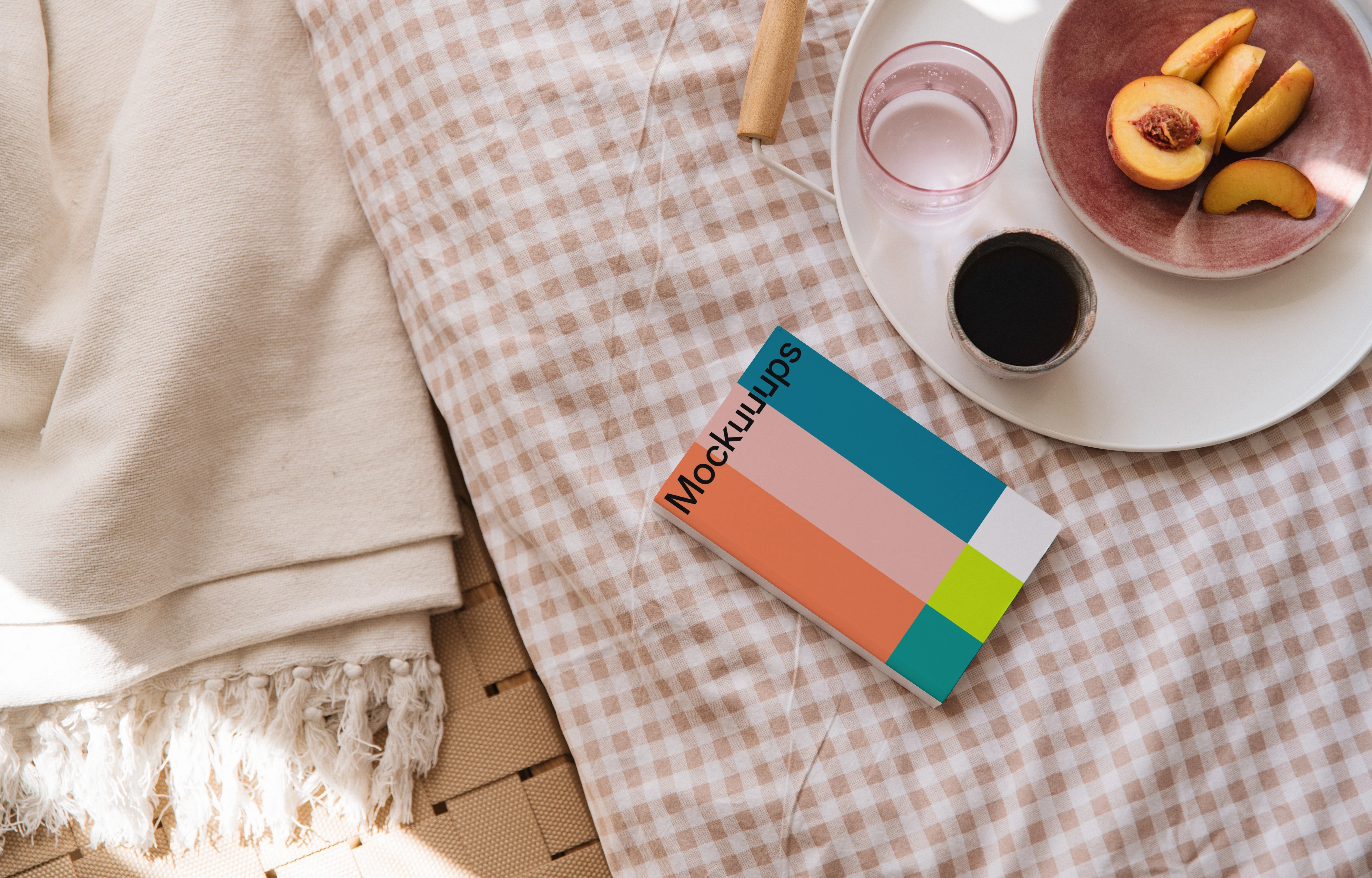 Softcover book mockup on a cozy fabric surface