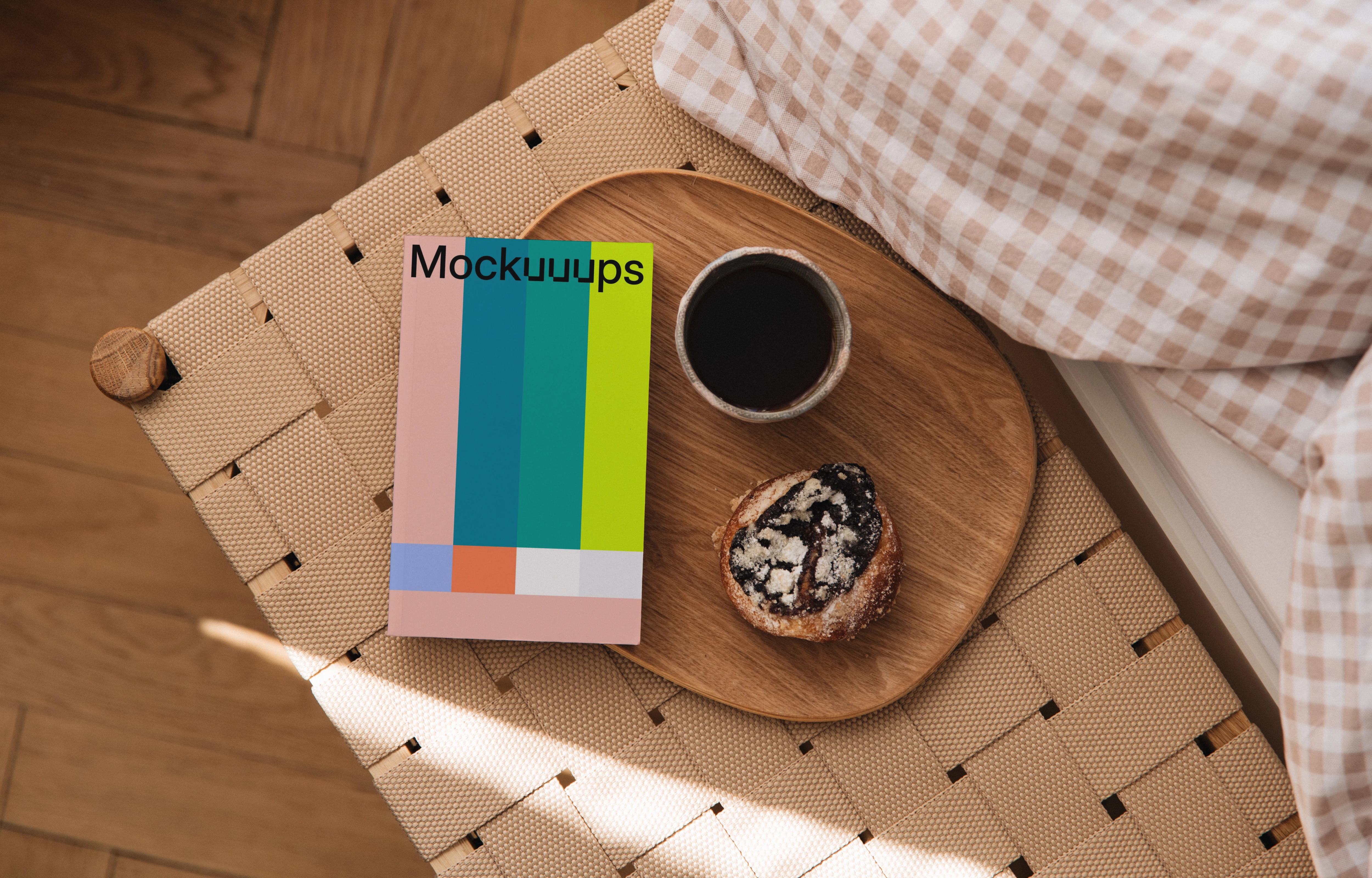 Softcover book mockup on a wooden tray with coffee and pastry