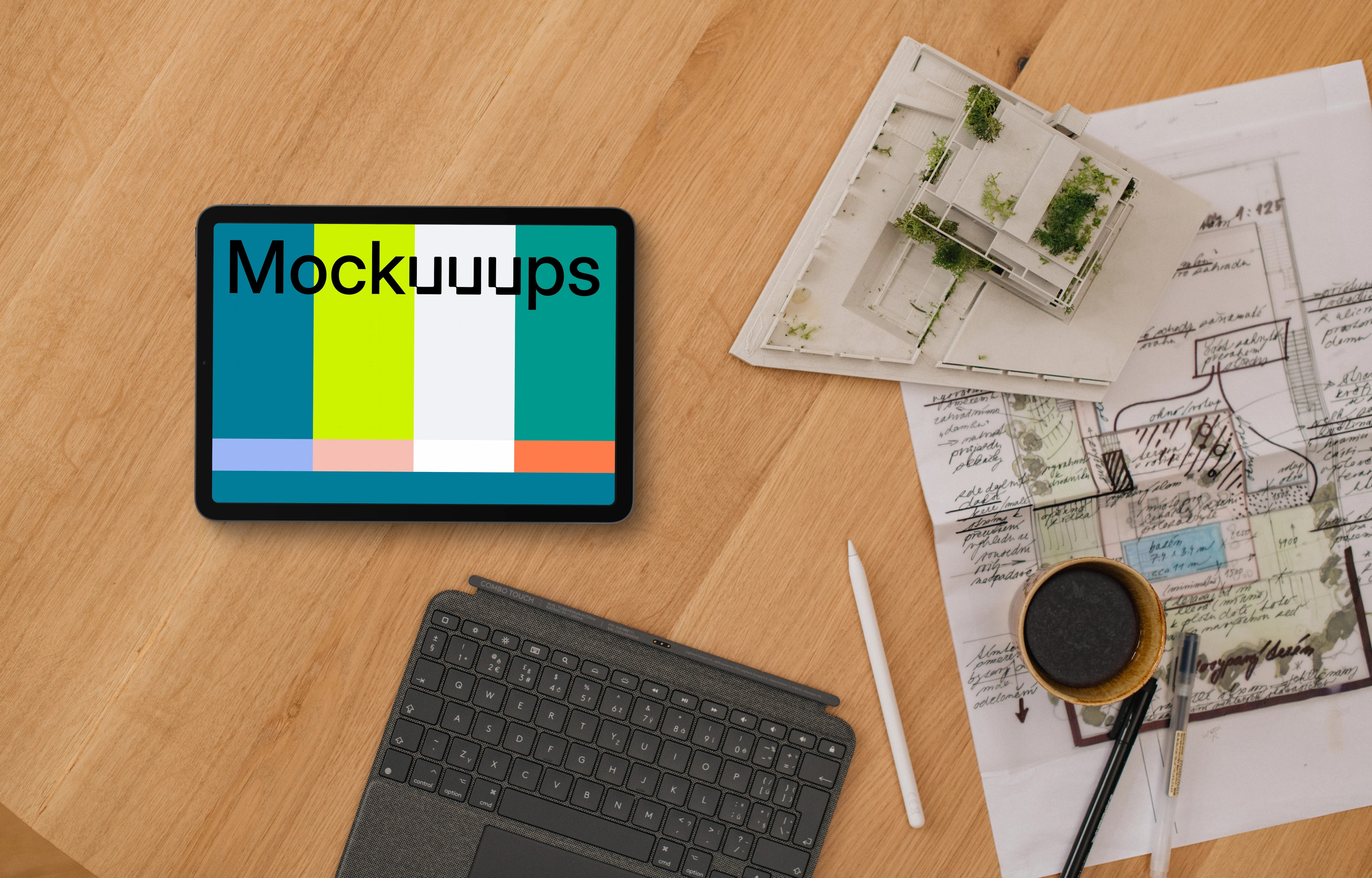 Tablet mockup with architect plans and coffee