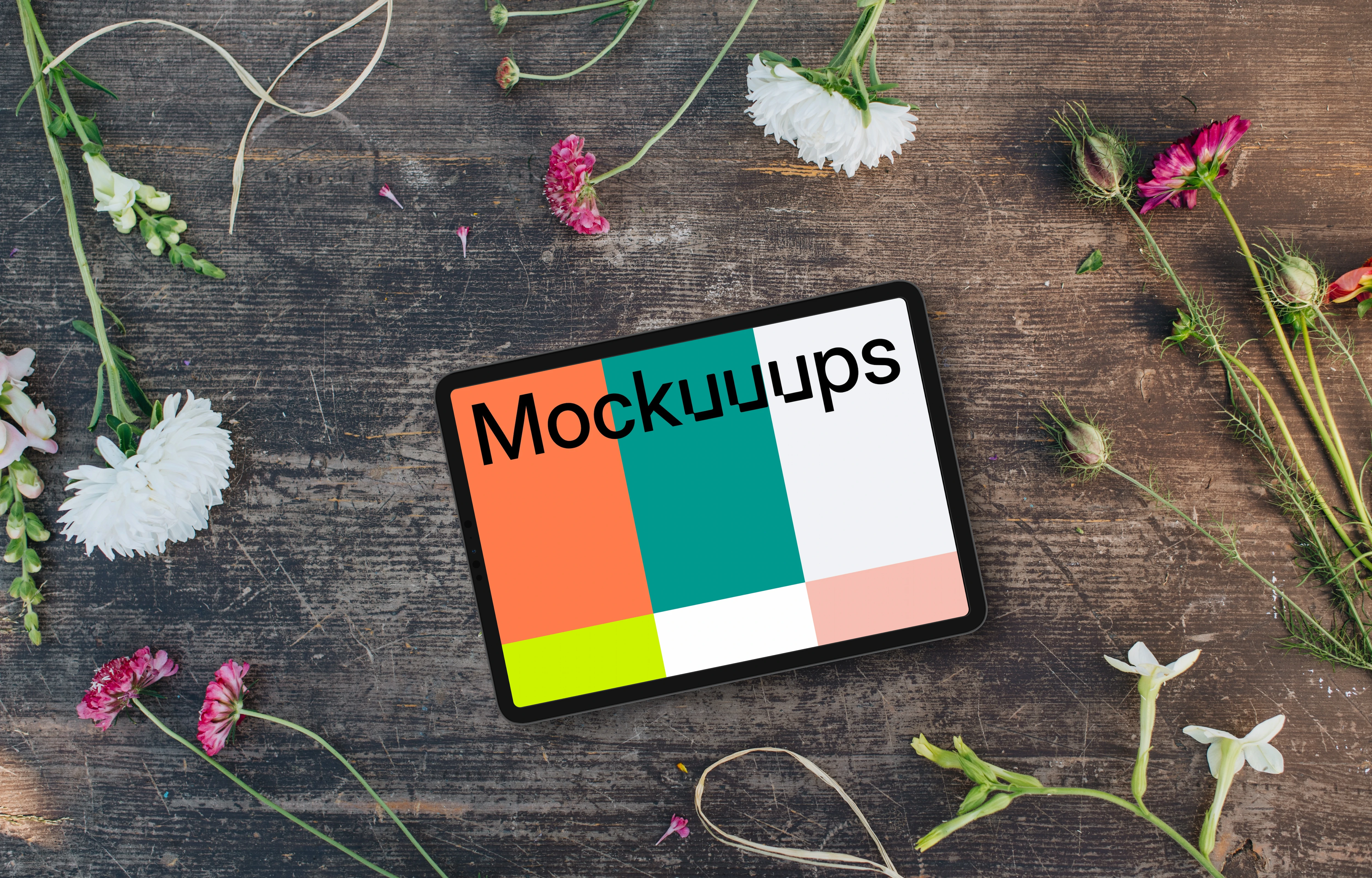 Top view of landscape tablet mockup next to flowers