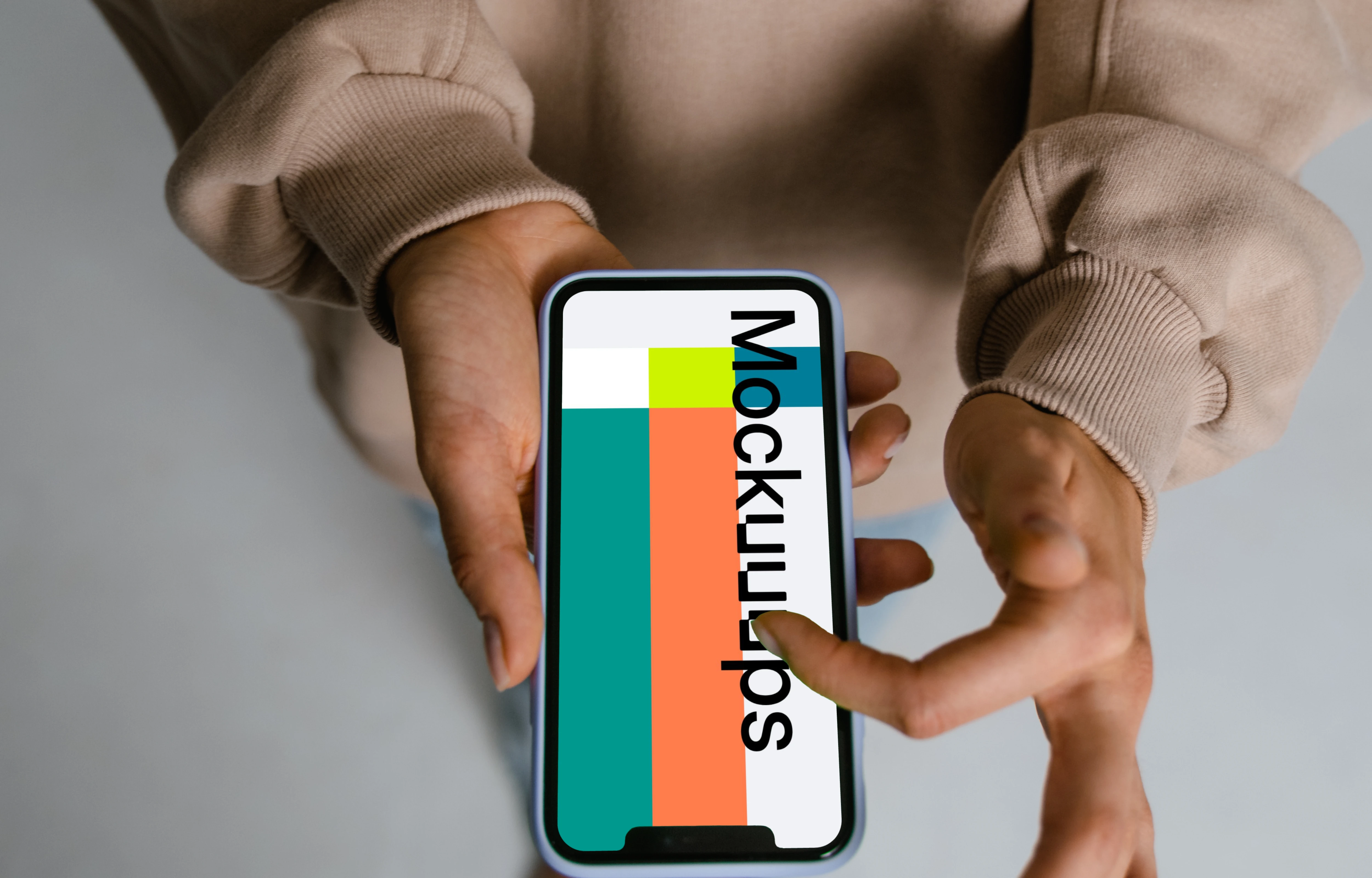 User in brown sweater scrolling through iPhone mockup