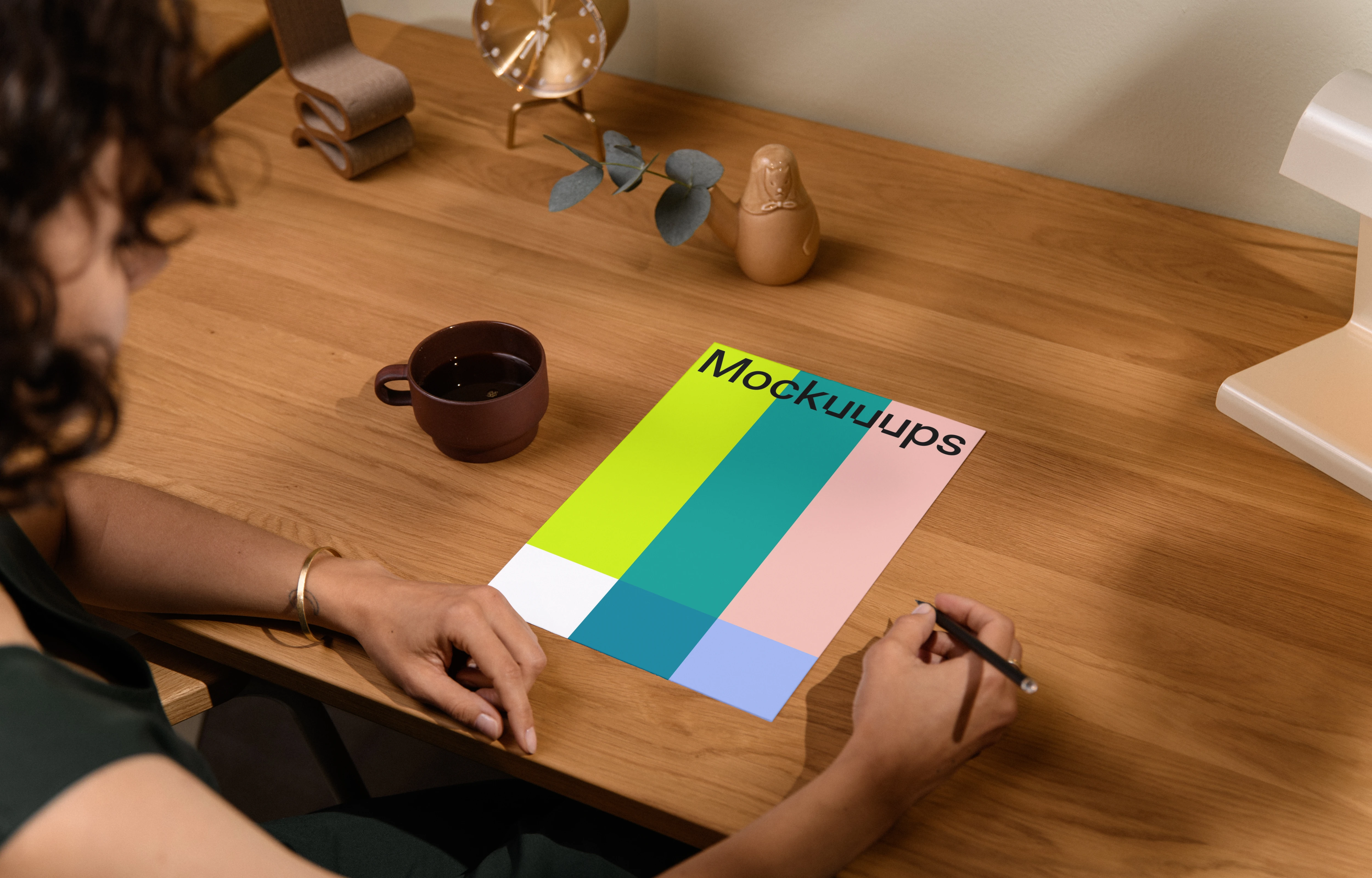 A4 mockup on a wooden desk with decor items