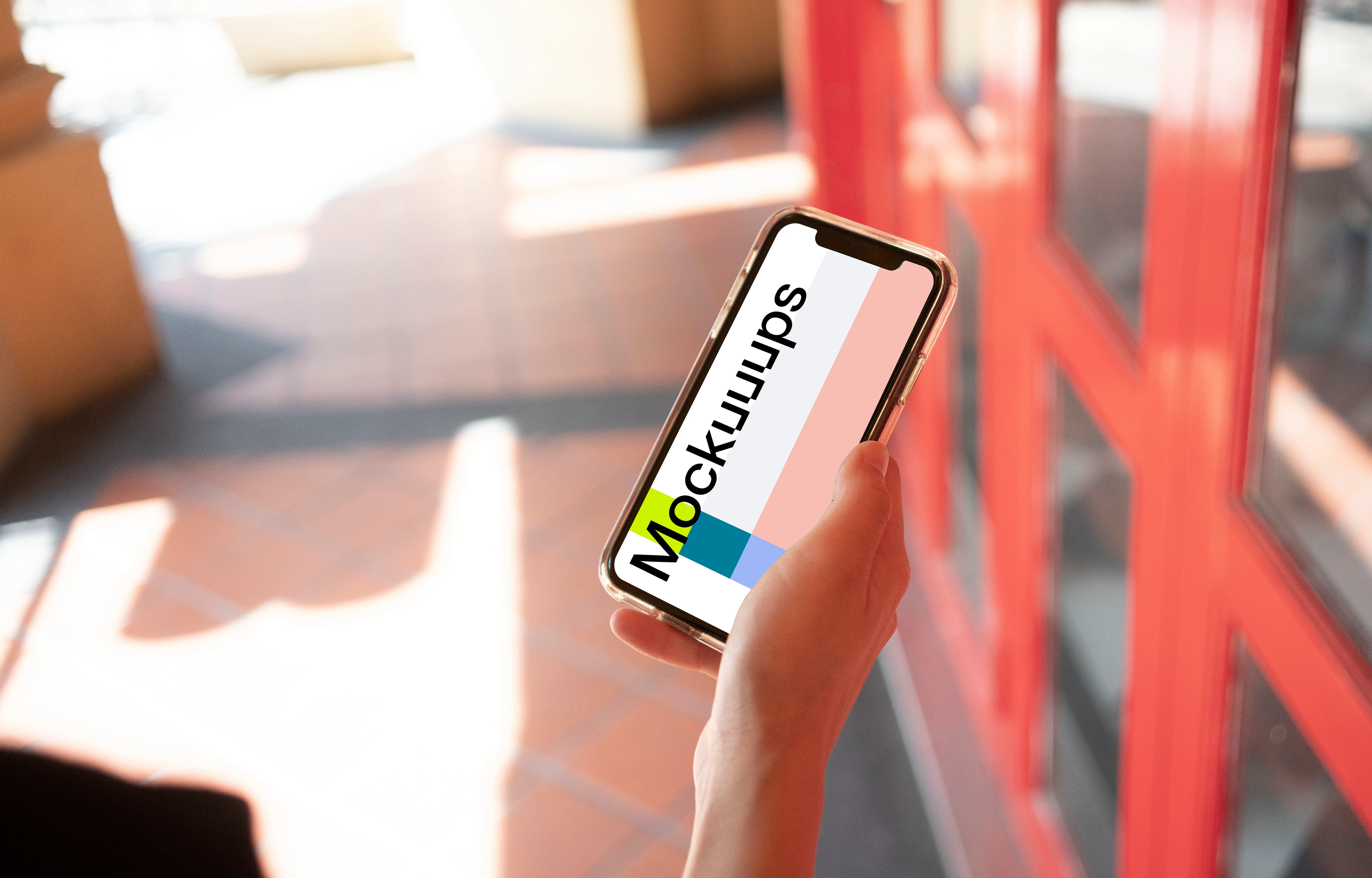 iPhone mockup held near red door.