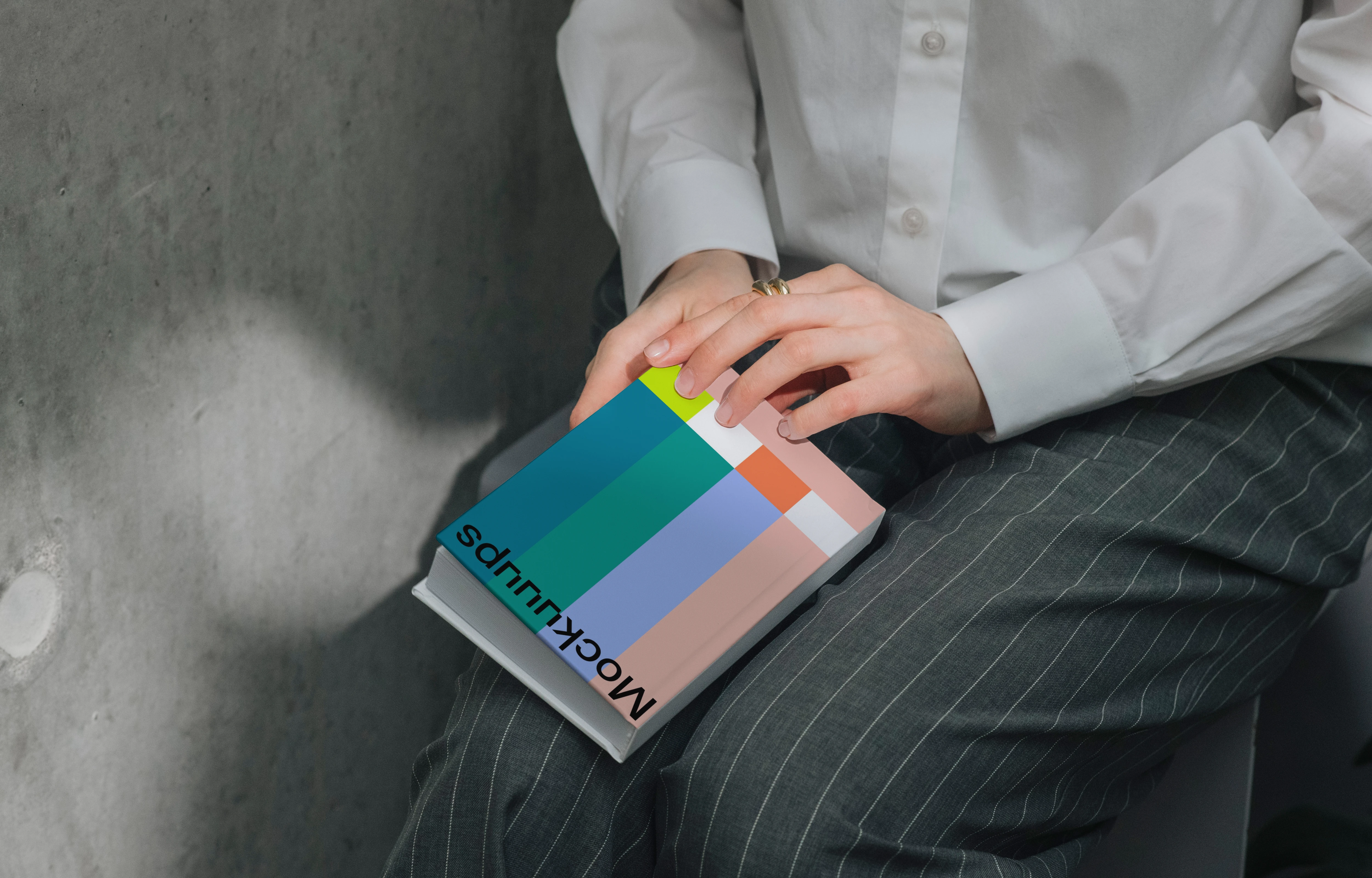 Book mockup resting on a person's lap in natural lighting