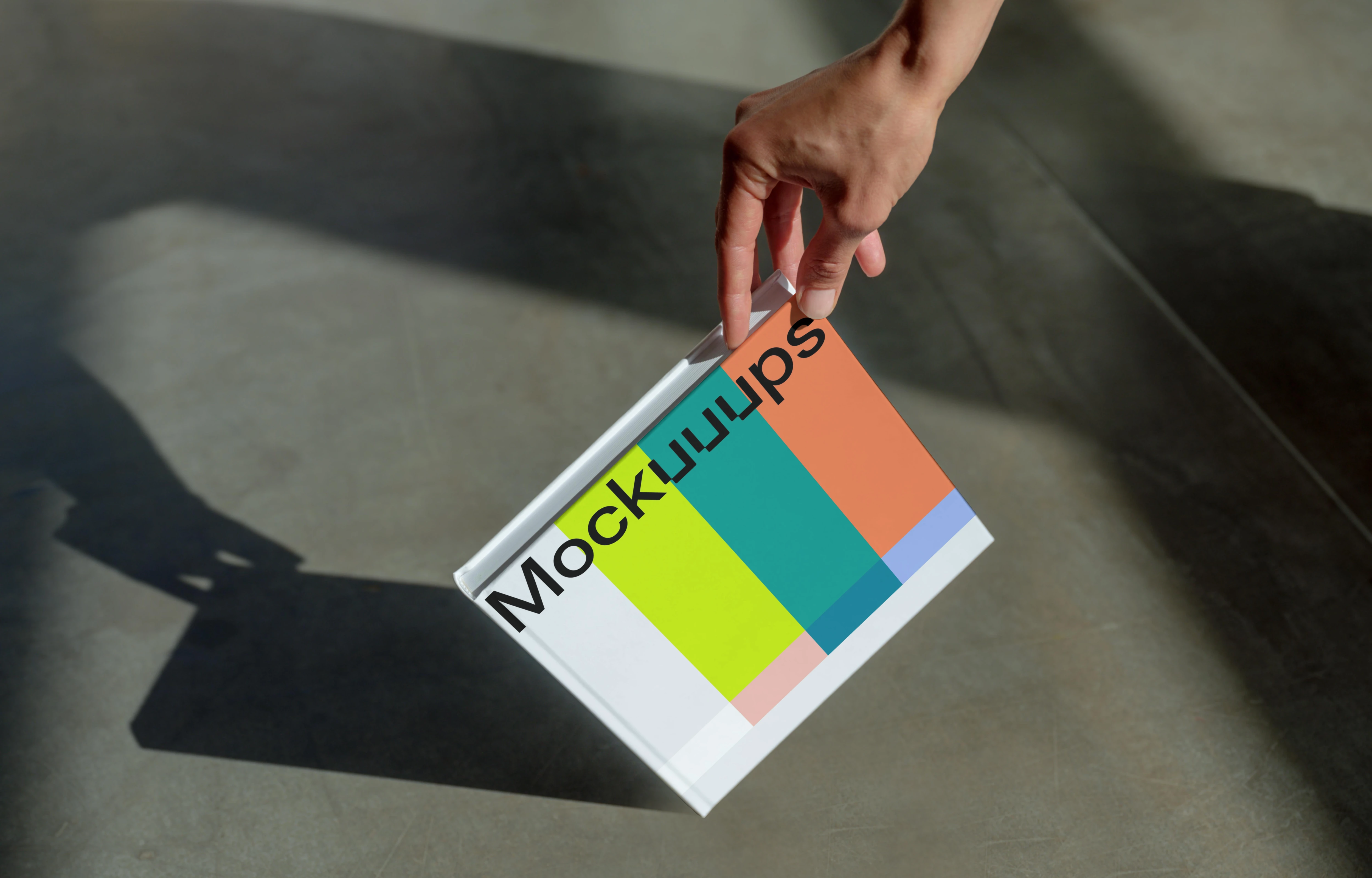 Book mockup with a gradient cover and hand detail