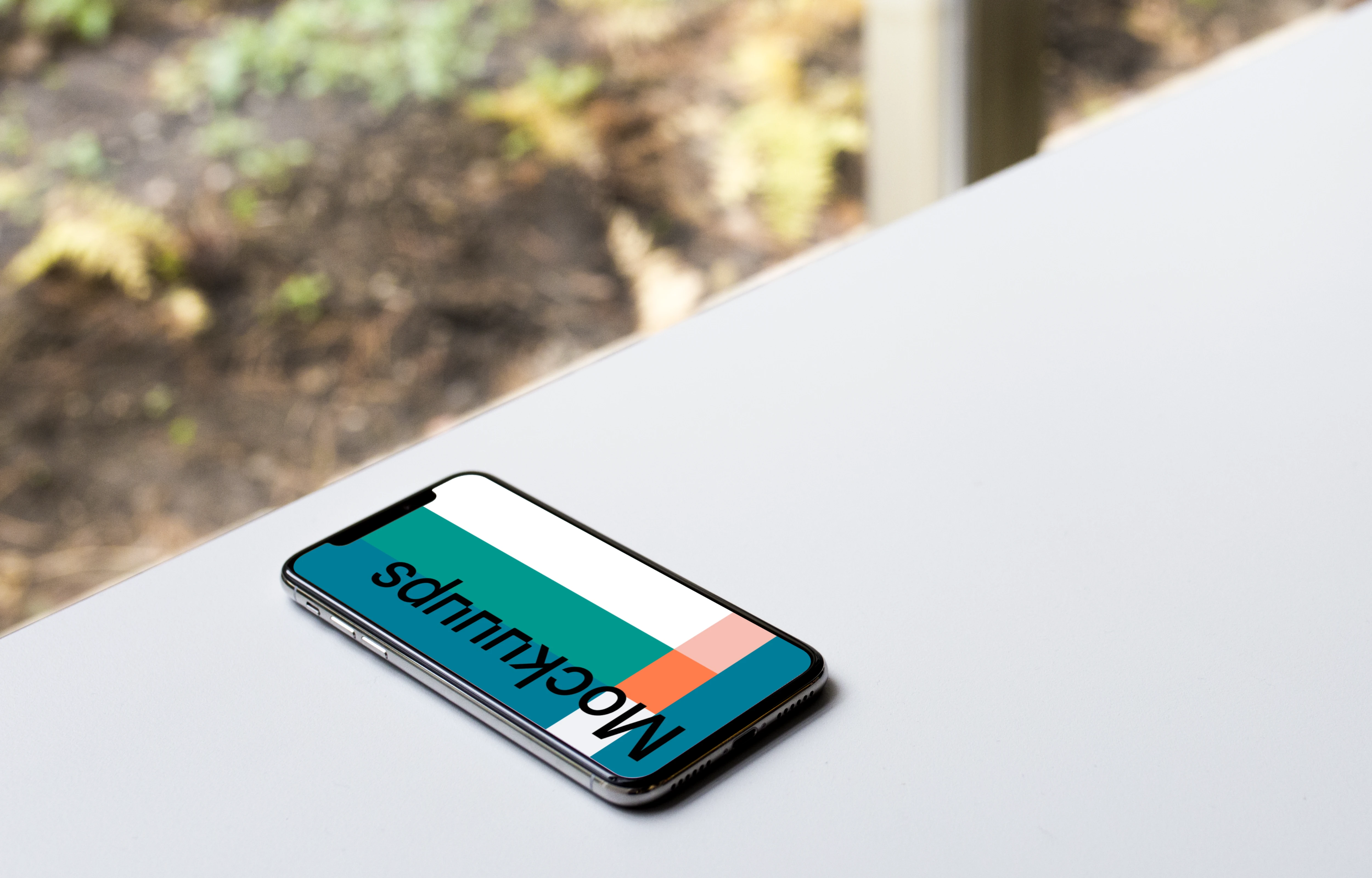Bright view of iPhone X mockup on the table