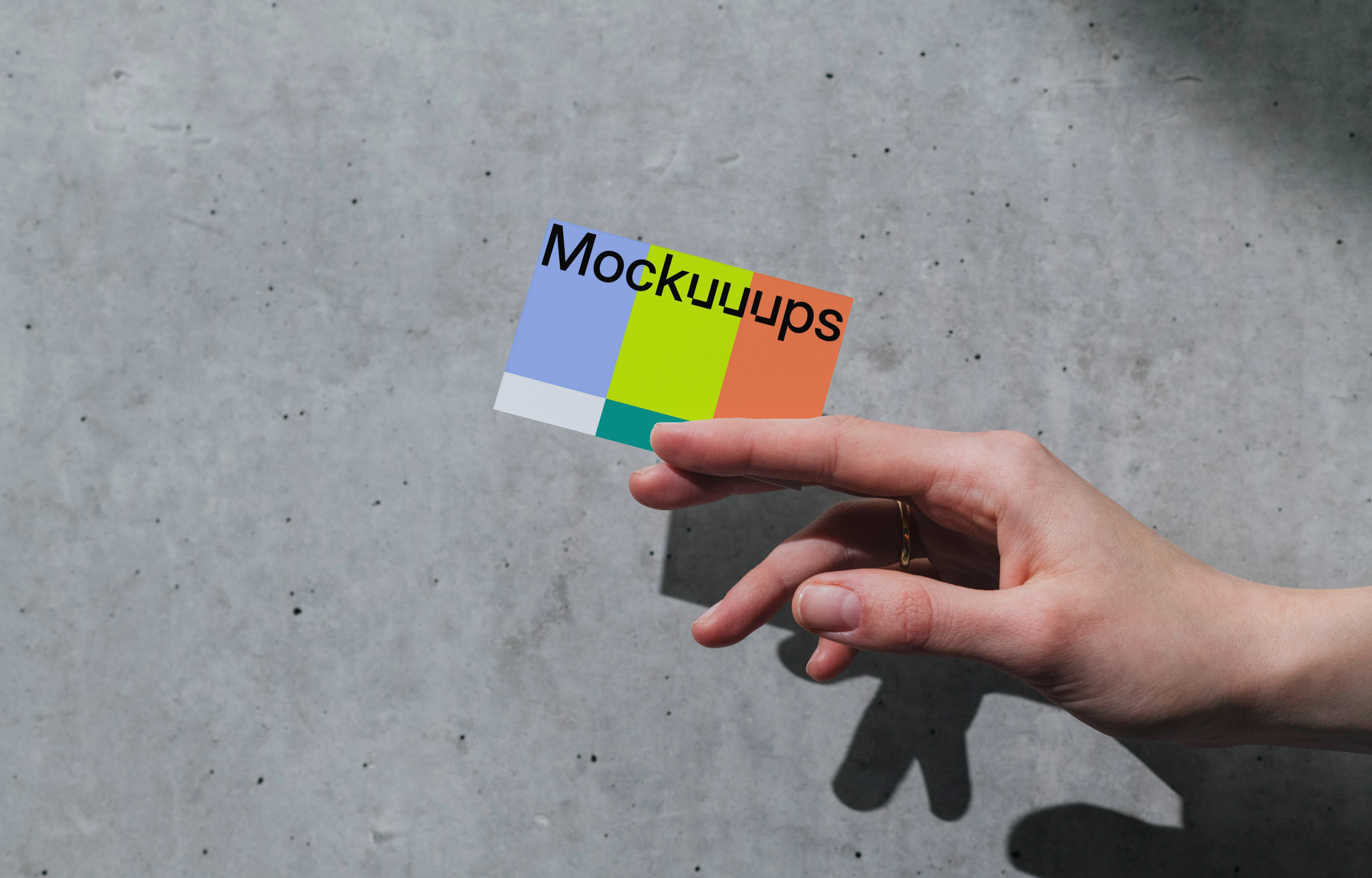 Business card mockup with hand on concrete background