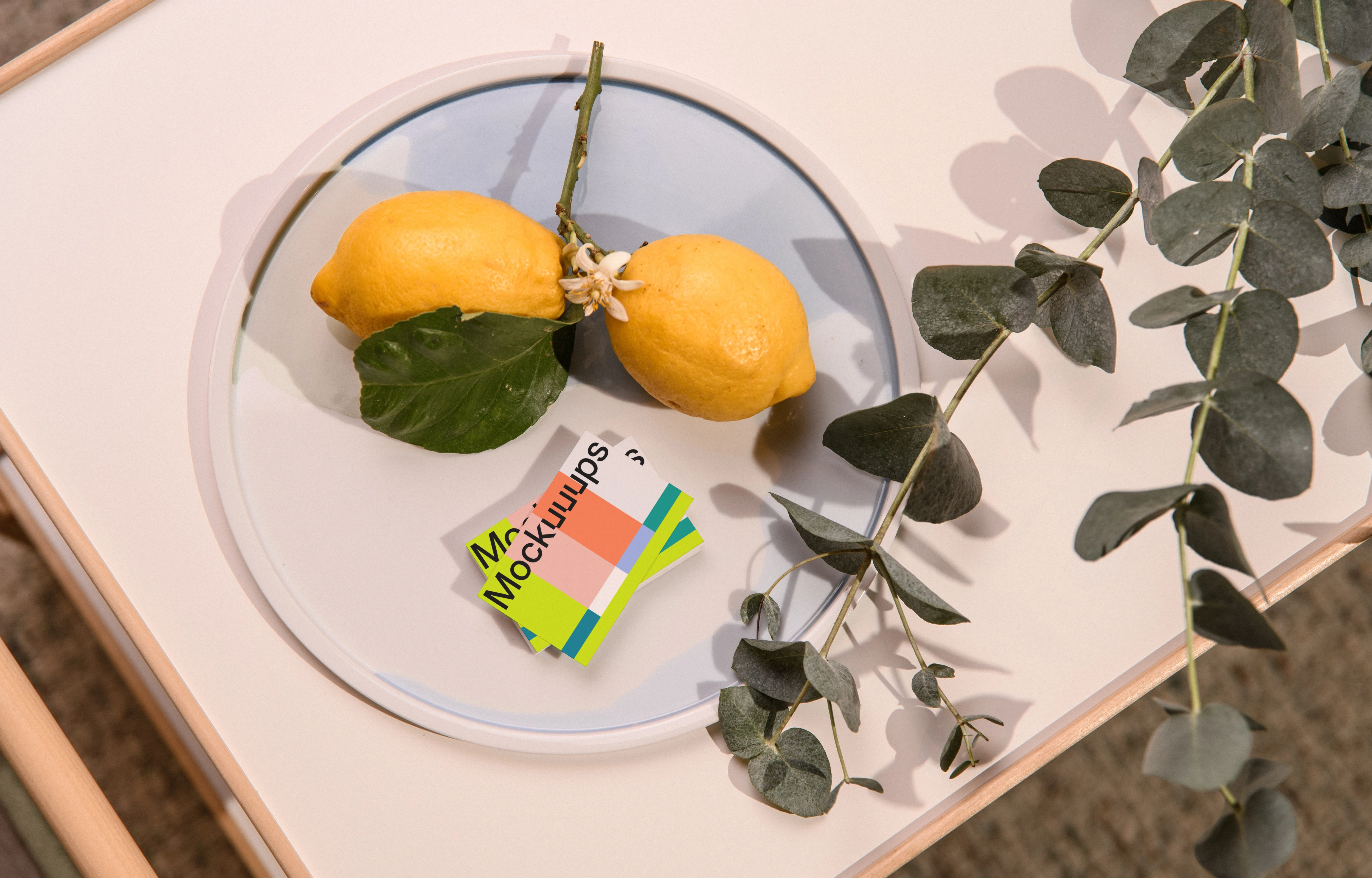 Business card mockup with lemons and eucalyptus