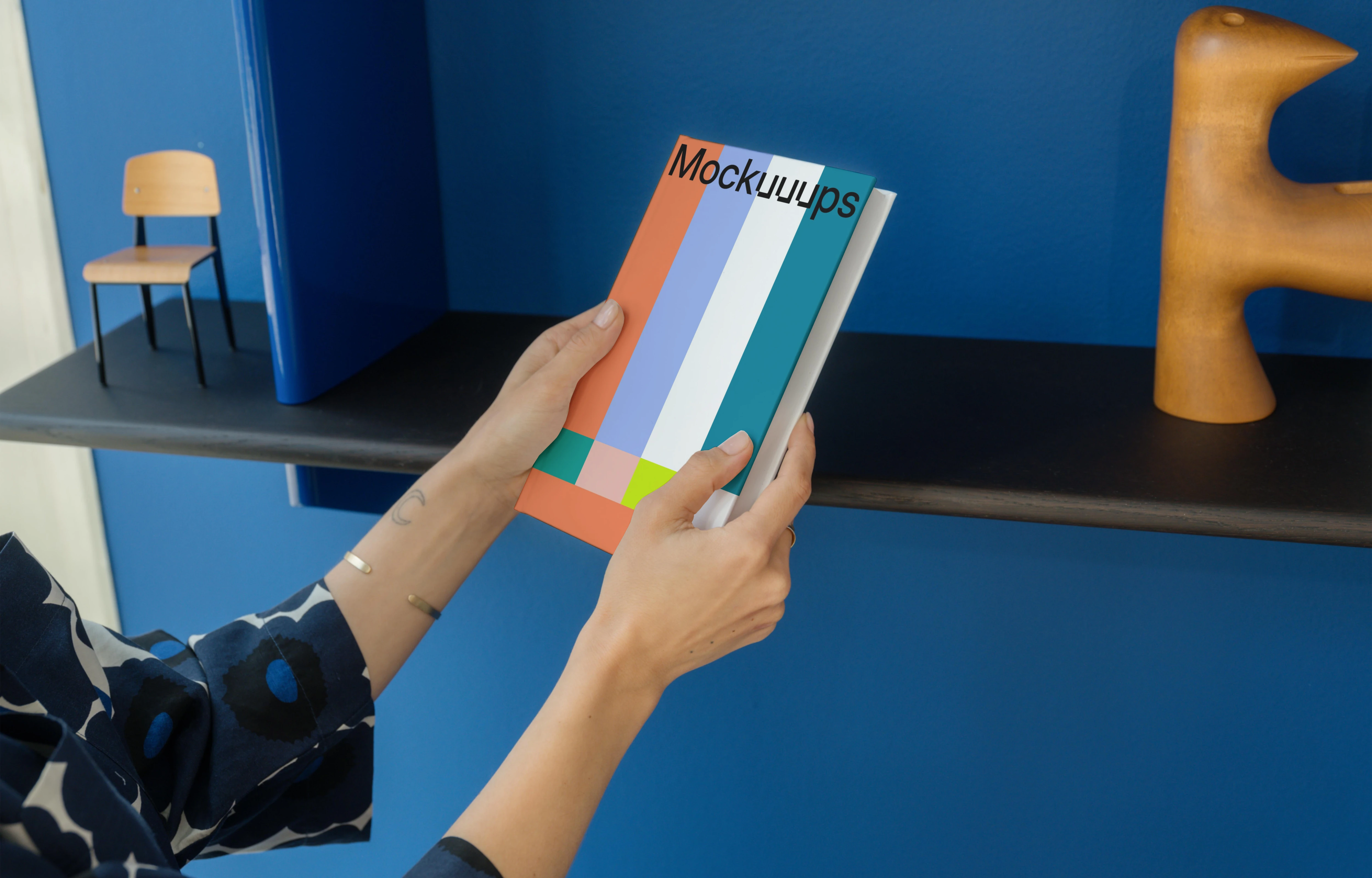 C-format book mockup held in a modern interior