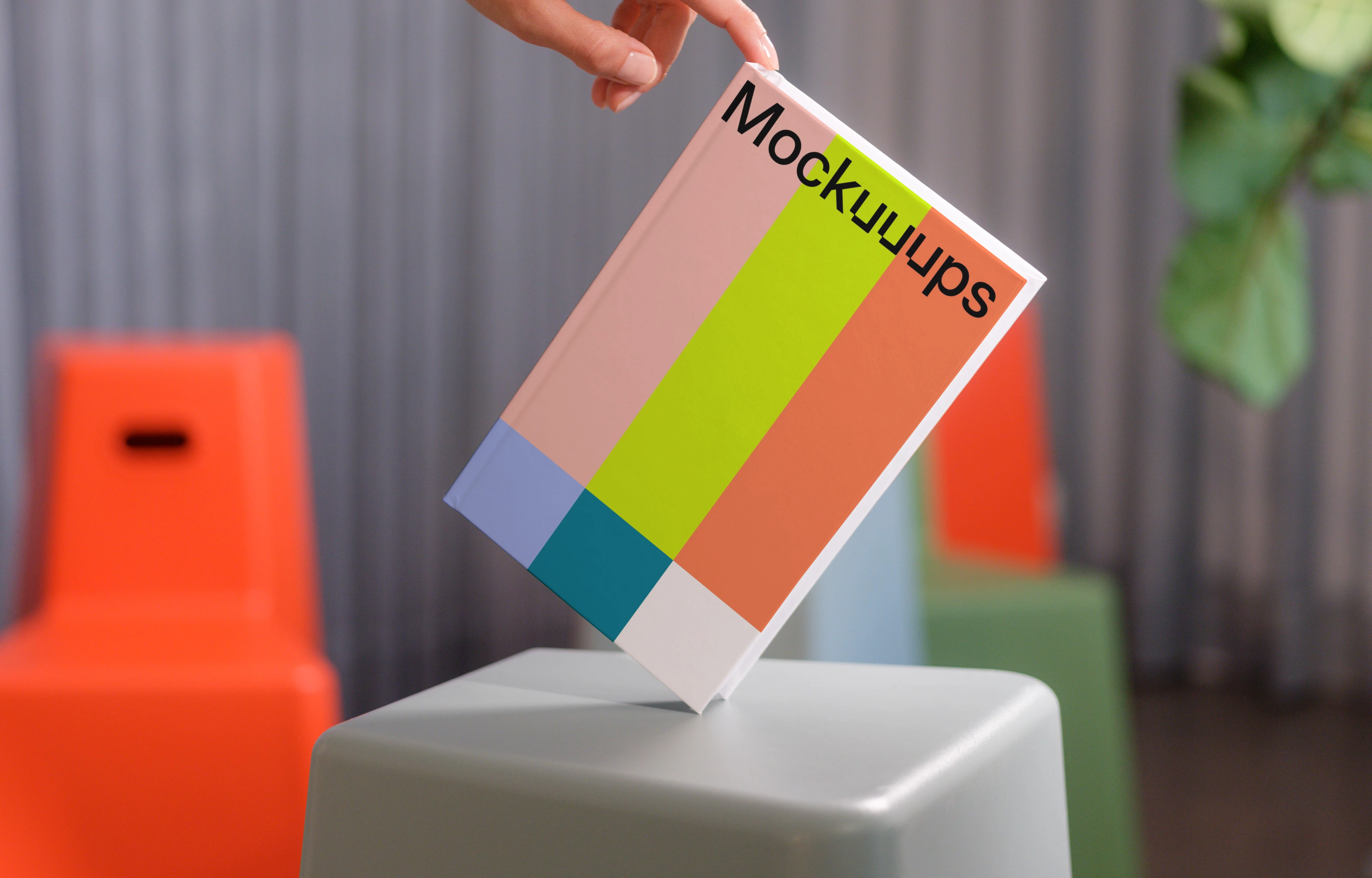 C-format book mockup held over modern stools