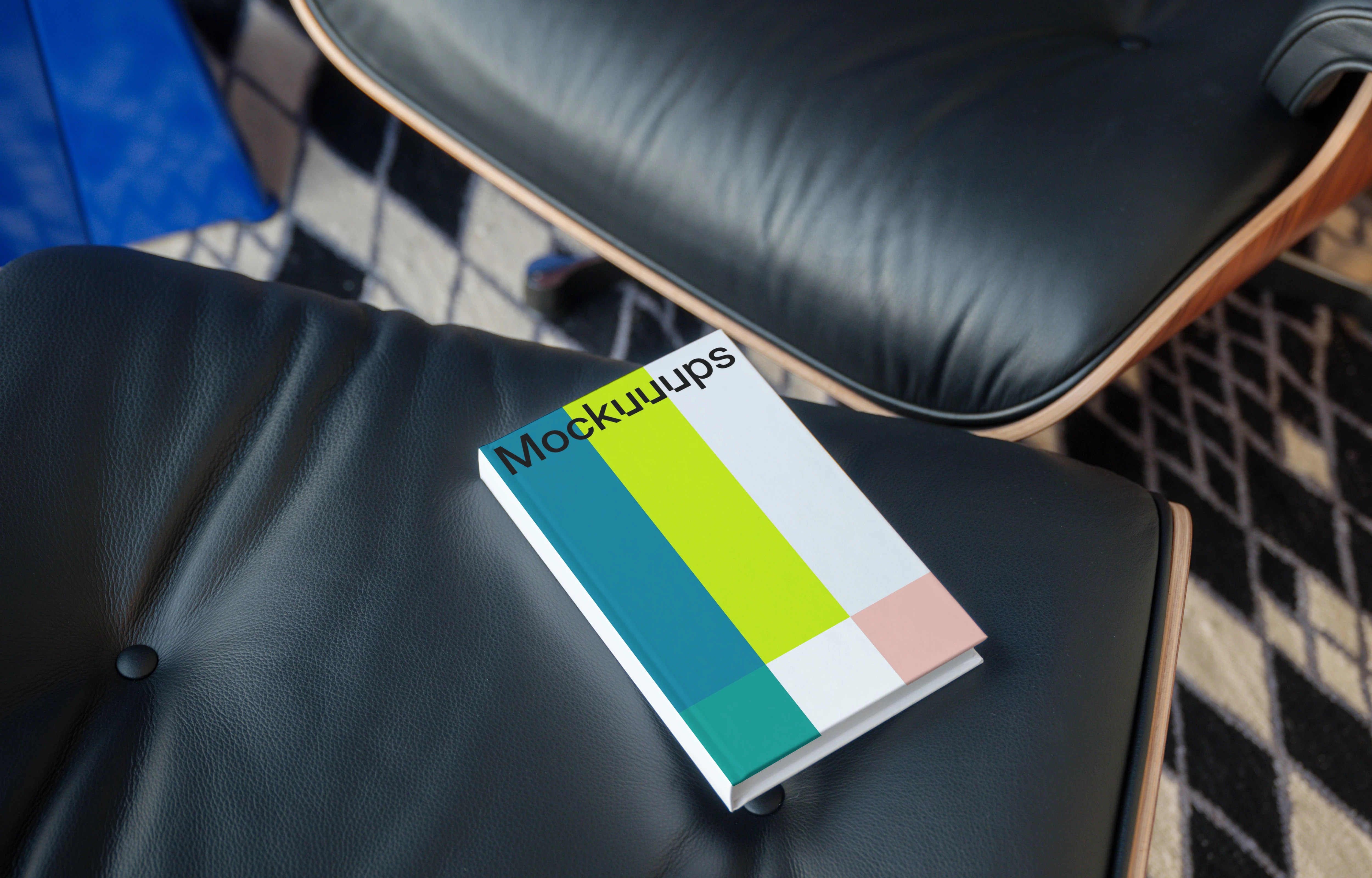 C-format book mockup on a leather chair in a modern setting