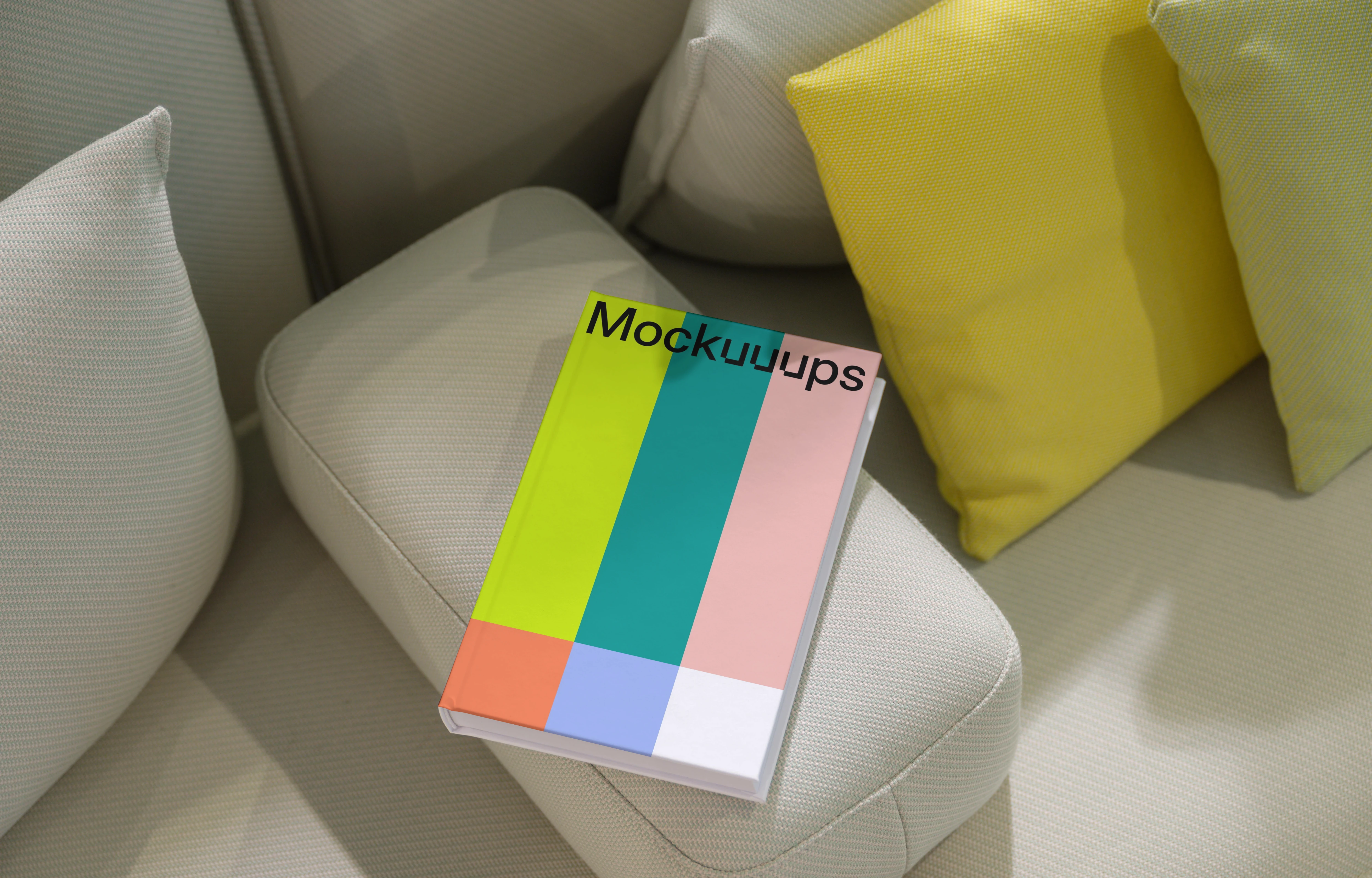 C-format book mockup on a modern sofa with cushions