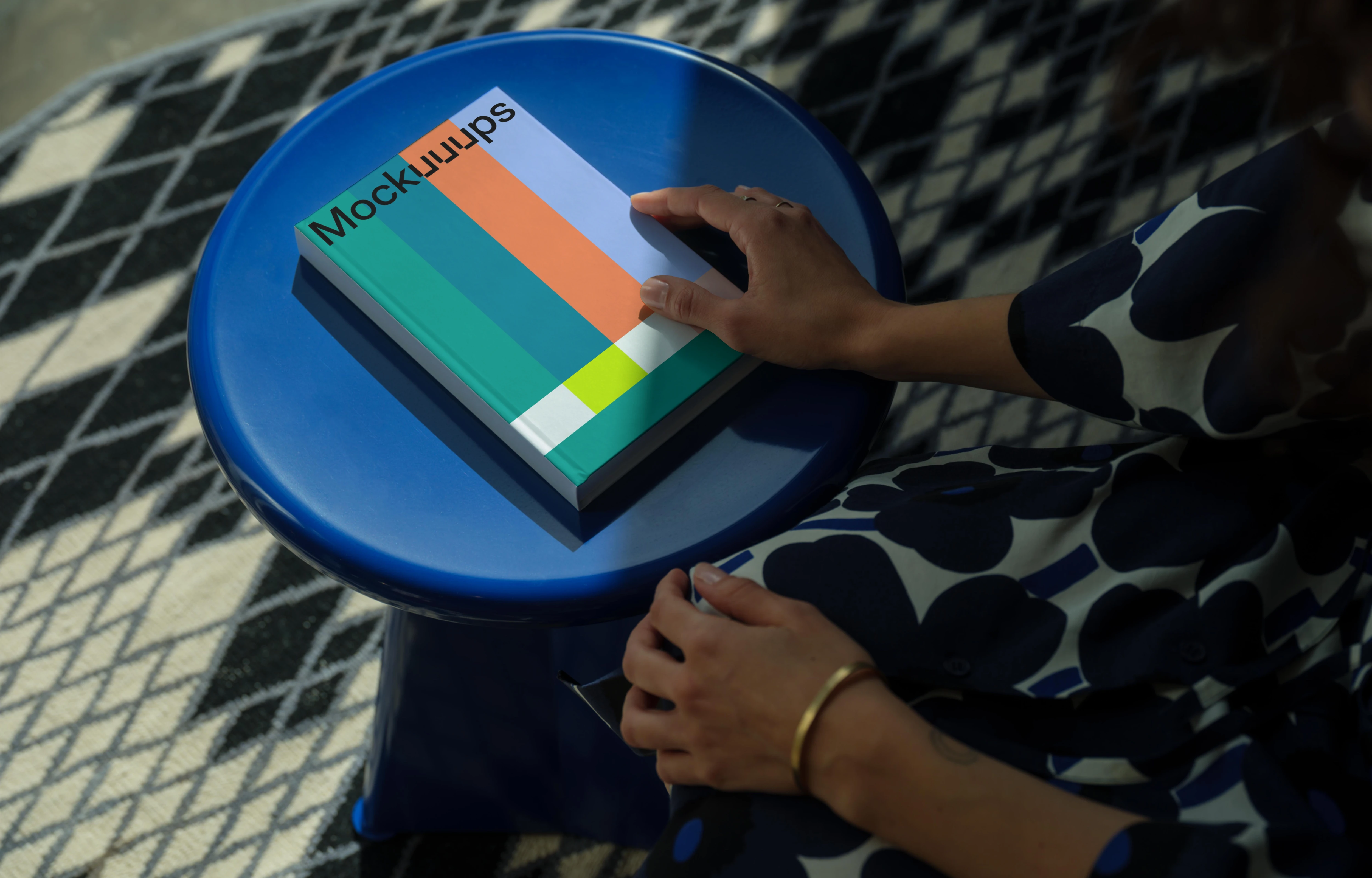 C-format book mockup on a round blue stool