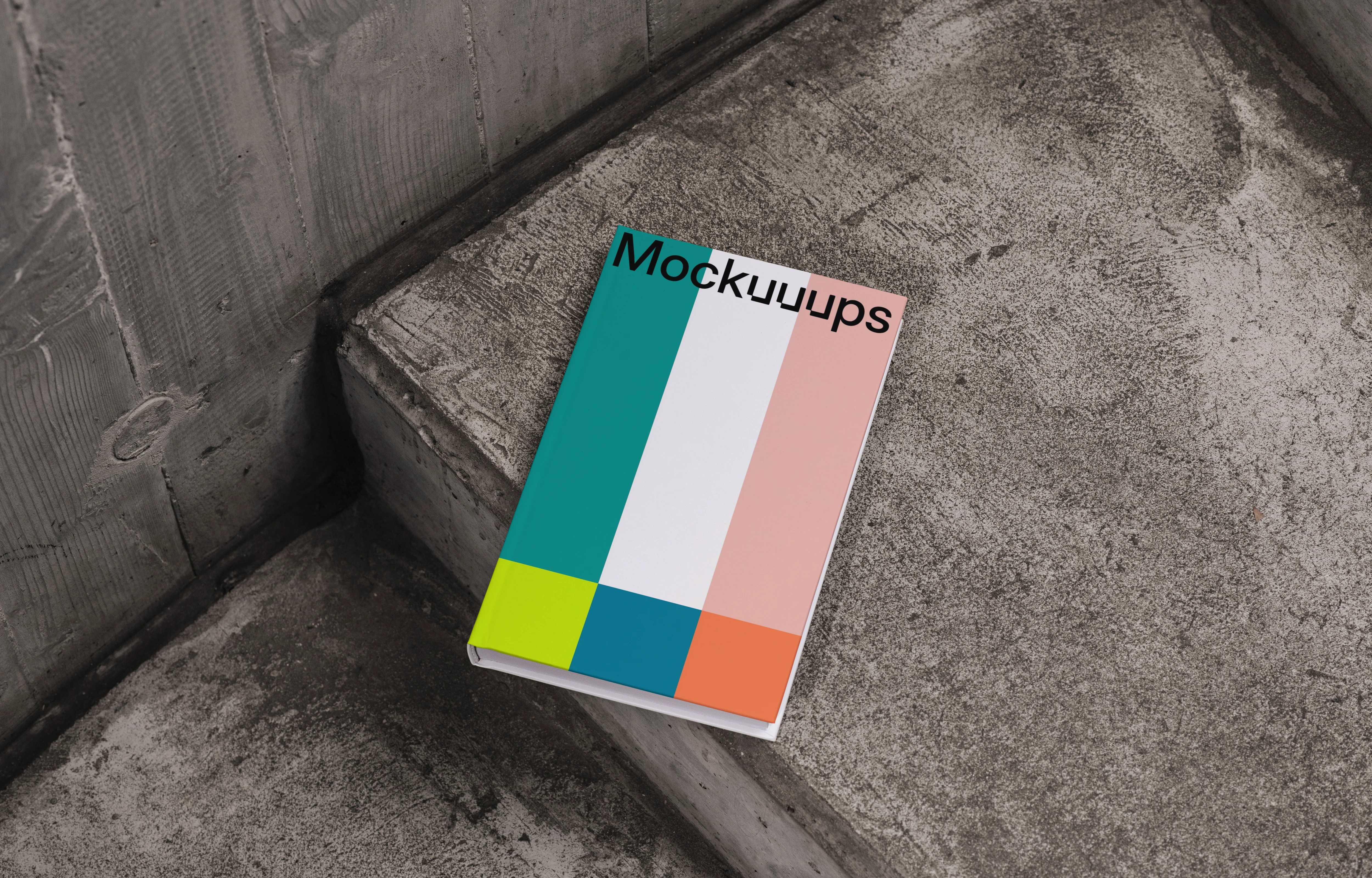 C-format book mockup on concrete stairs