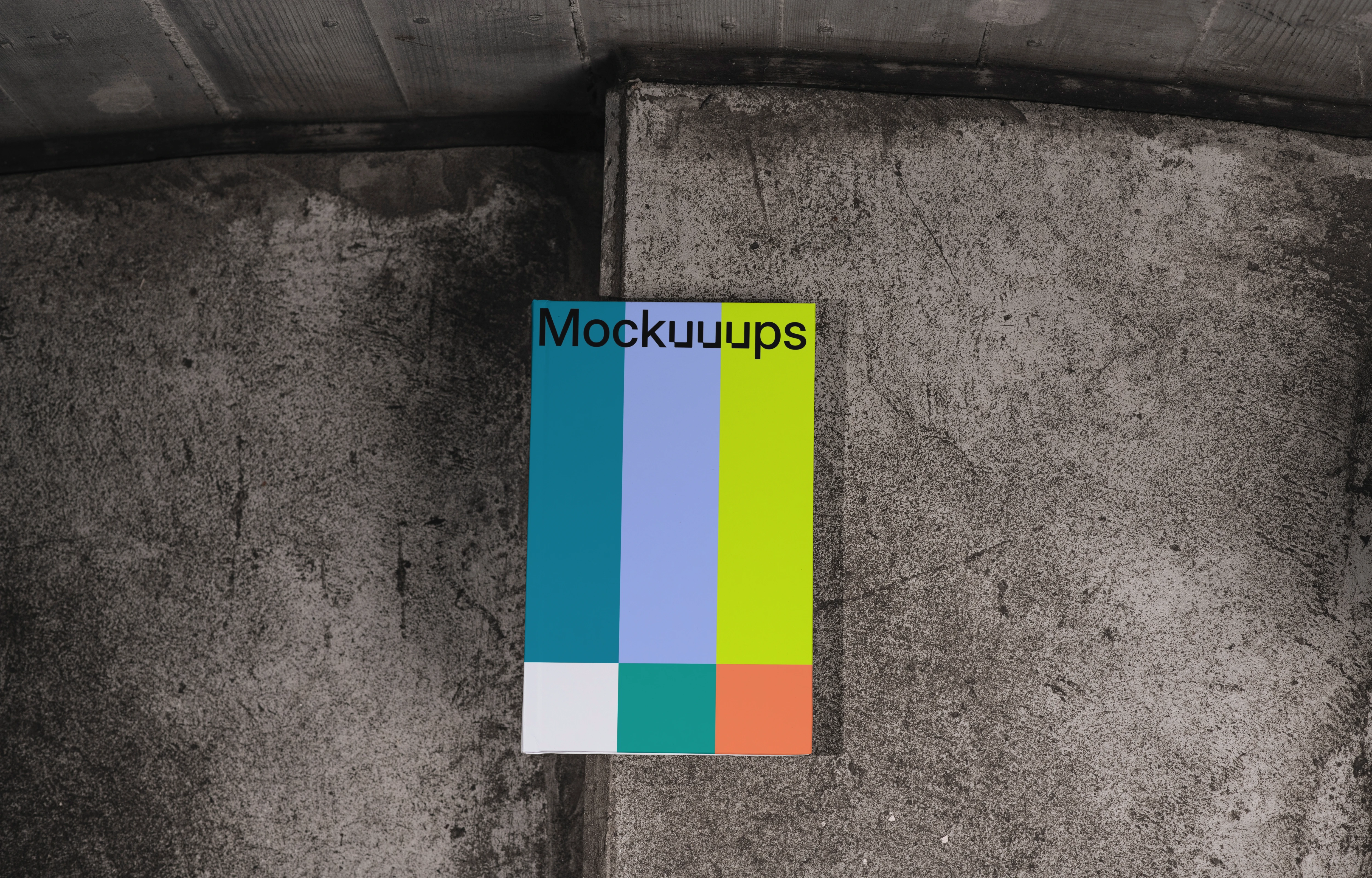 C-format book mockup on textured concrete background