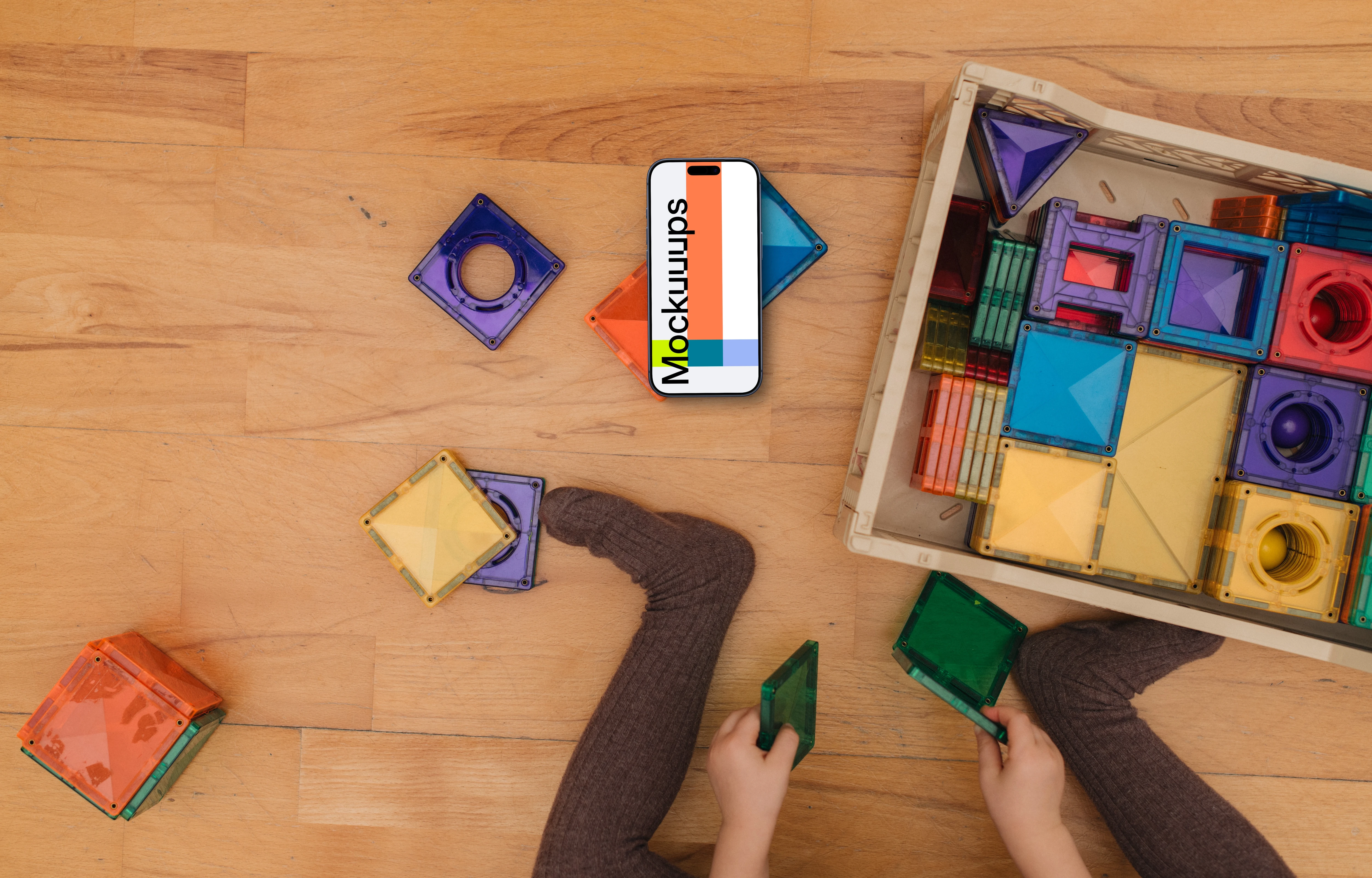 Children's play area mockup with smartphone and colorful toys