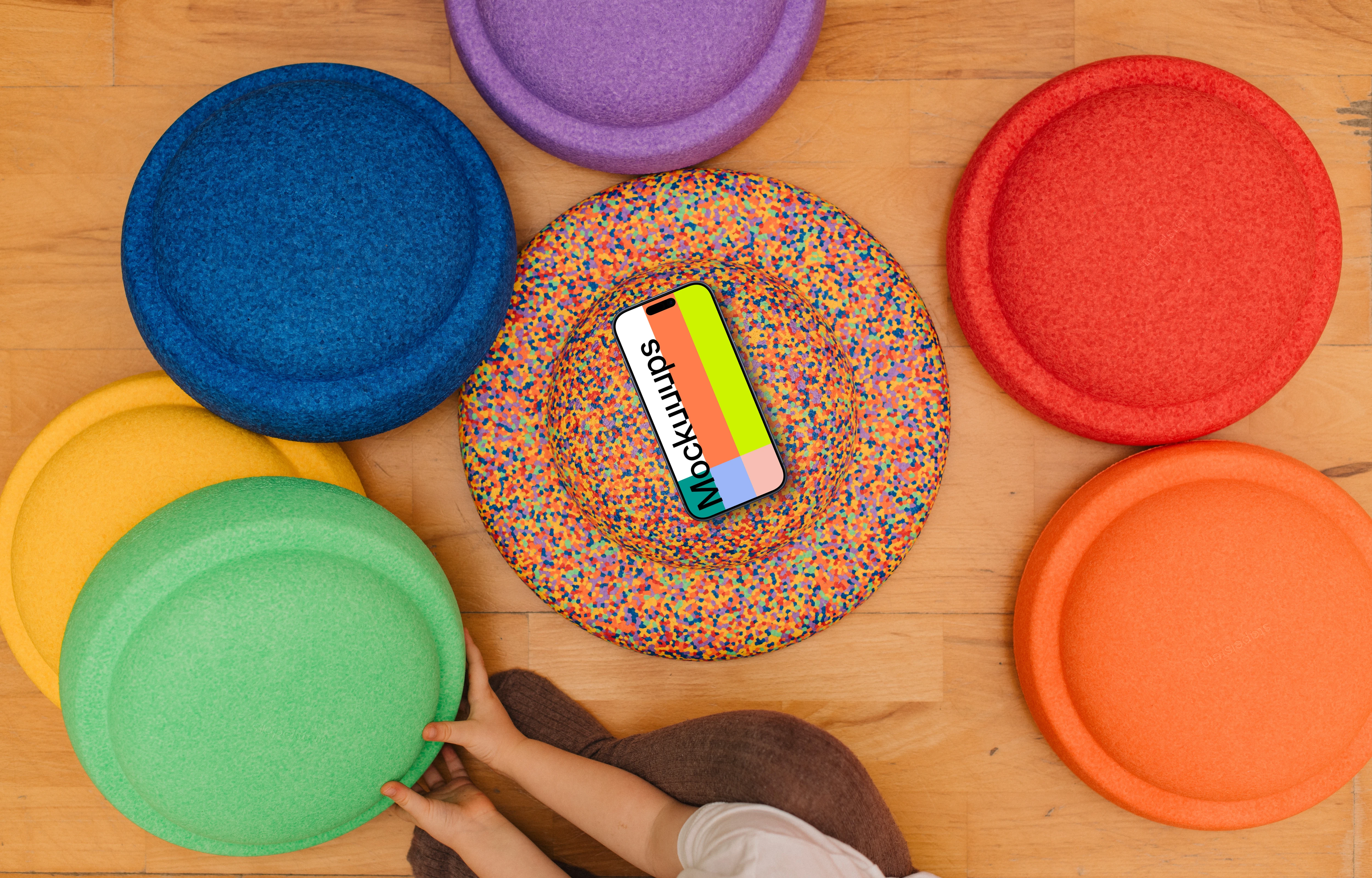 Colorful play mats mockup with smartphone and child interaction