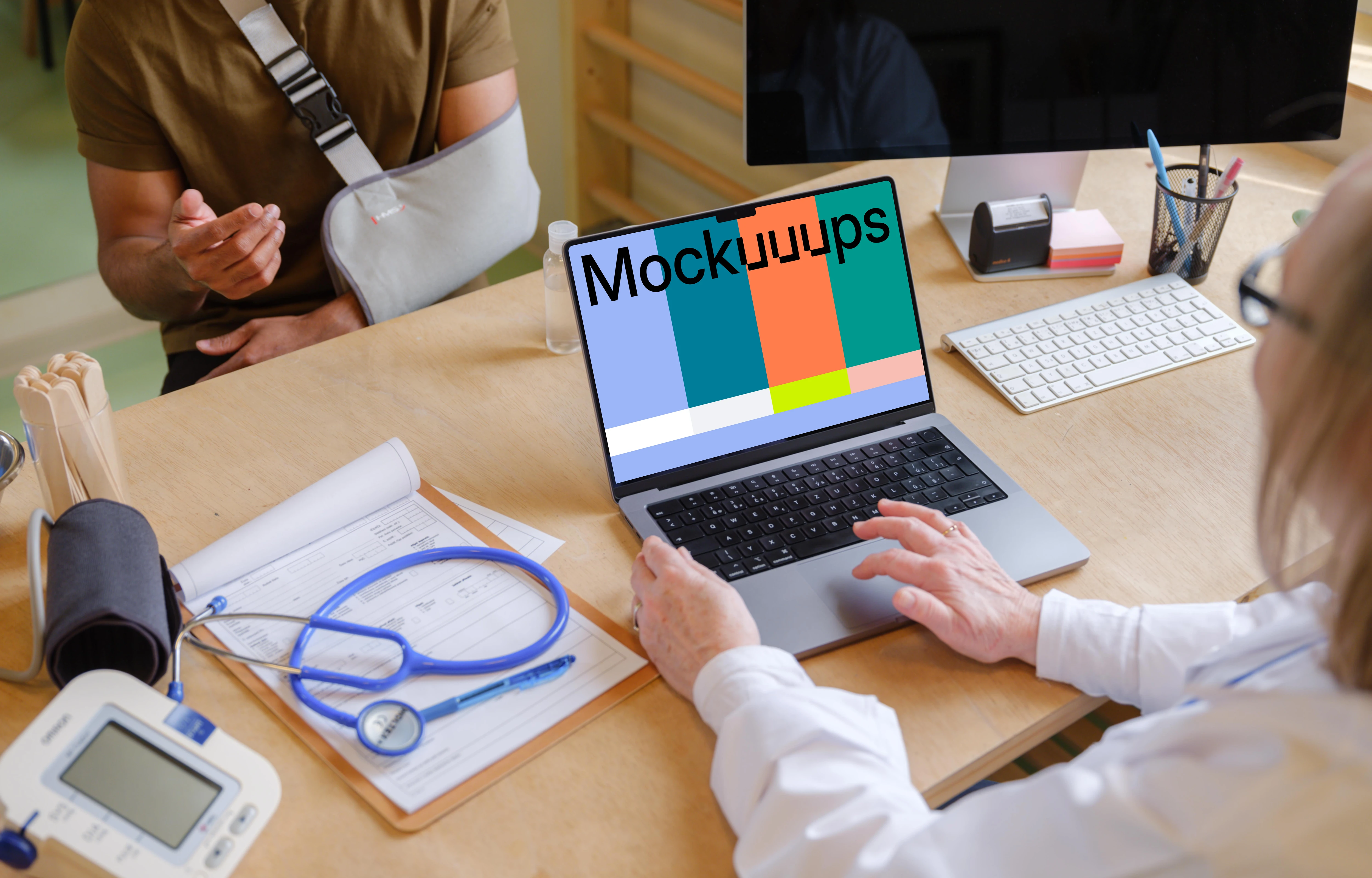 Doctor typing on laptop while talking with the patient