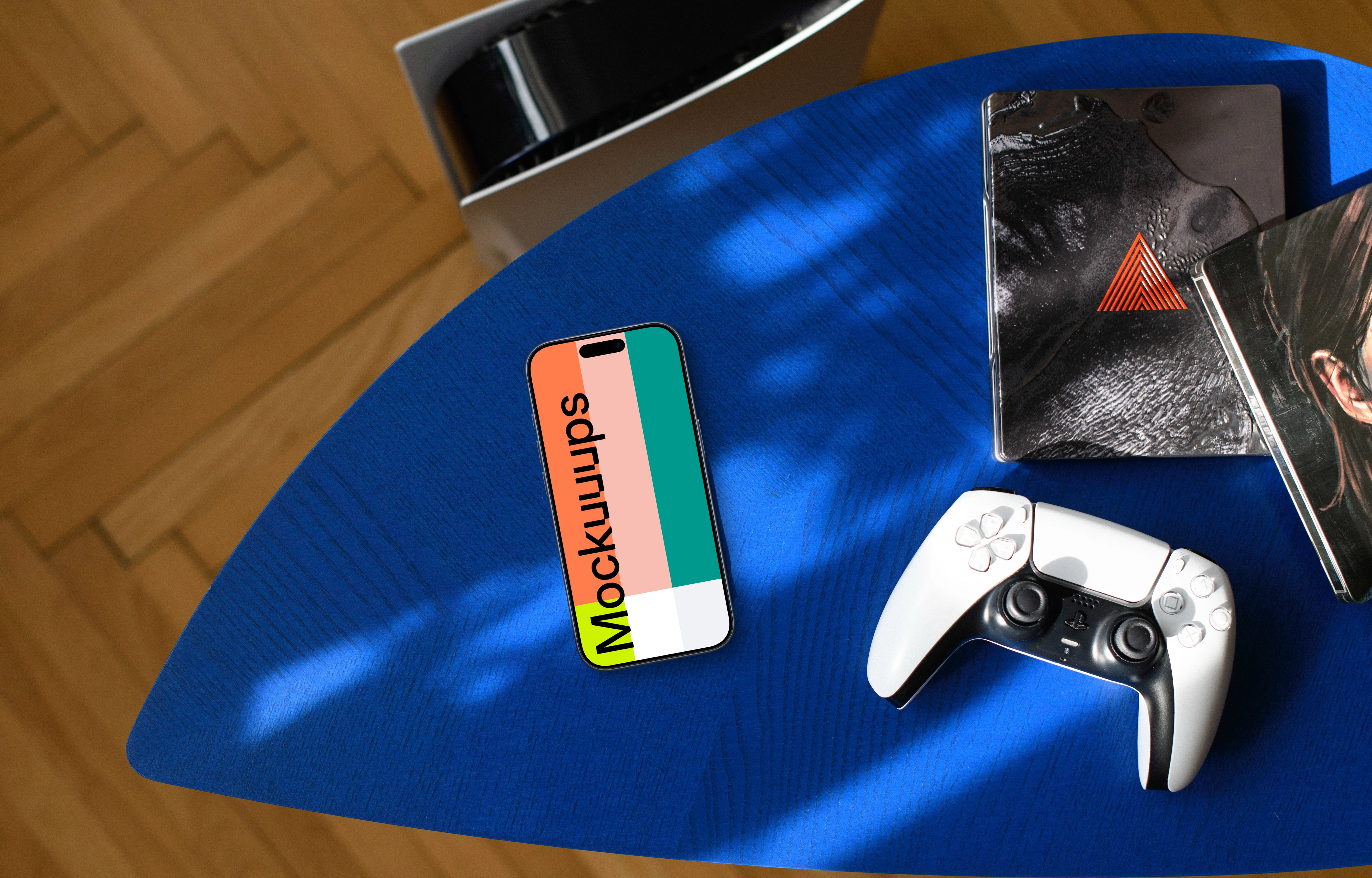 Smartphone mockup with gaming accessories on blue surface