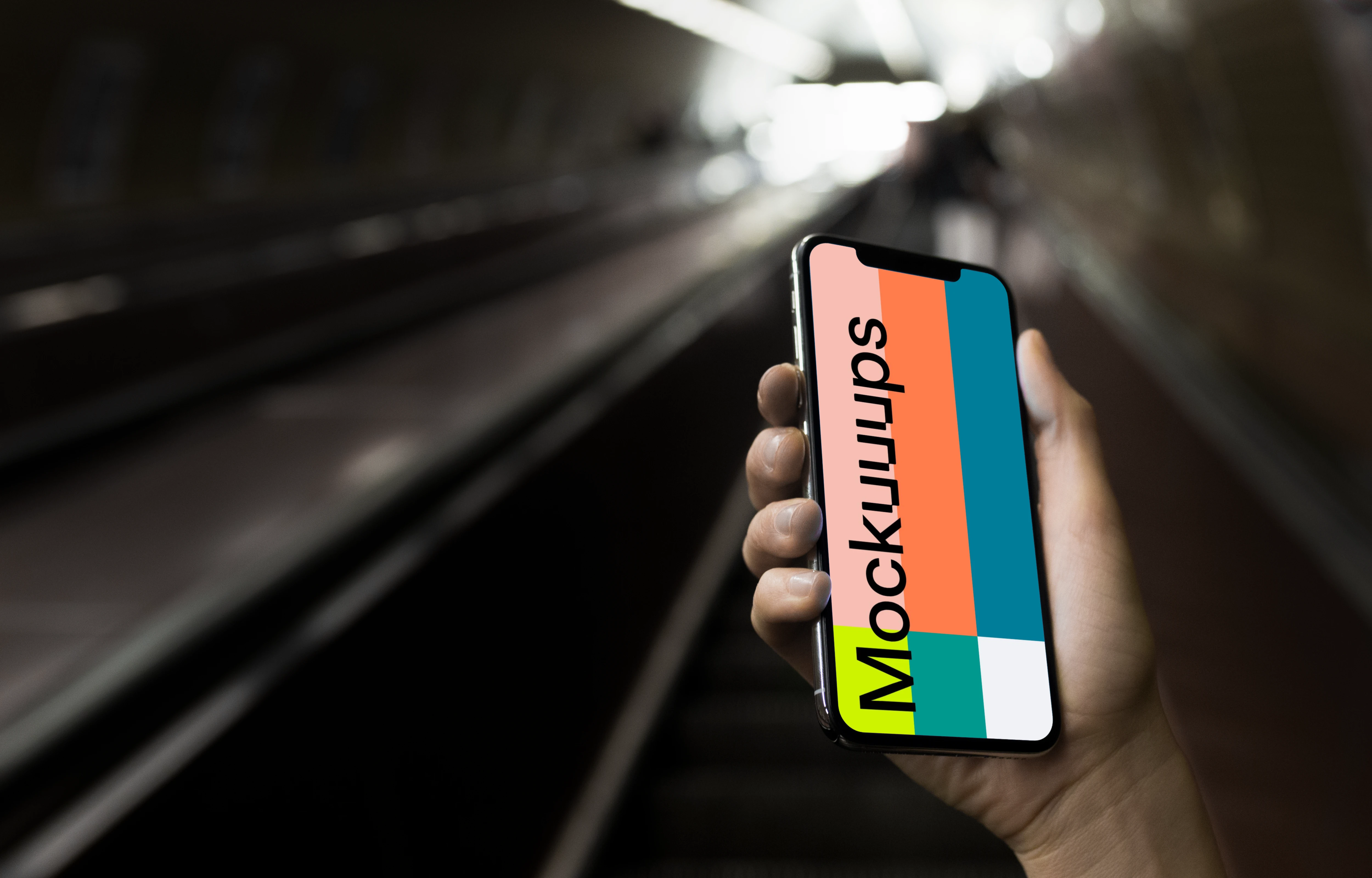 iPhone X mockup in front of underground Entrance