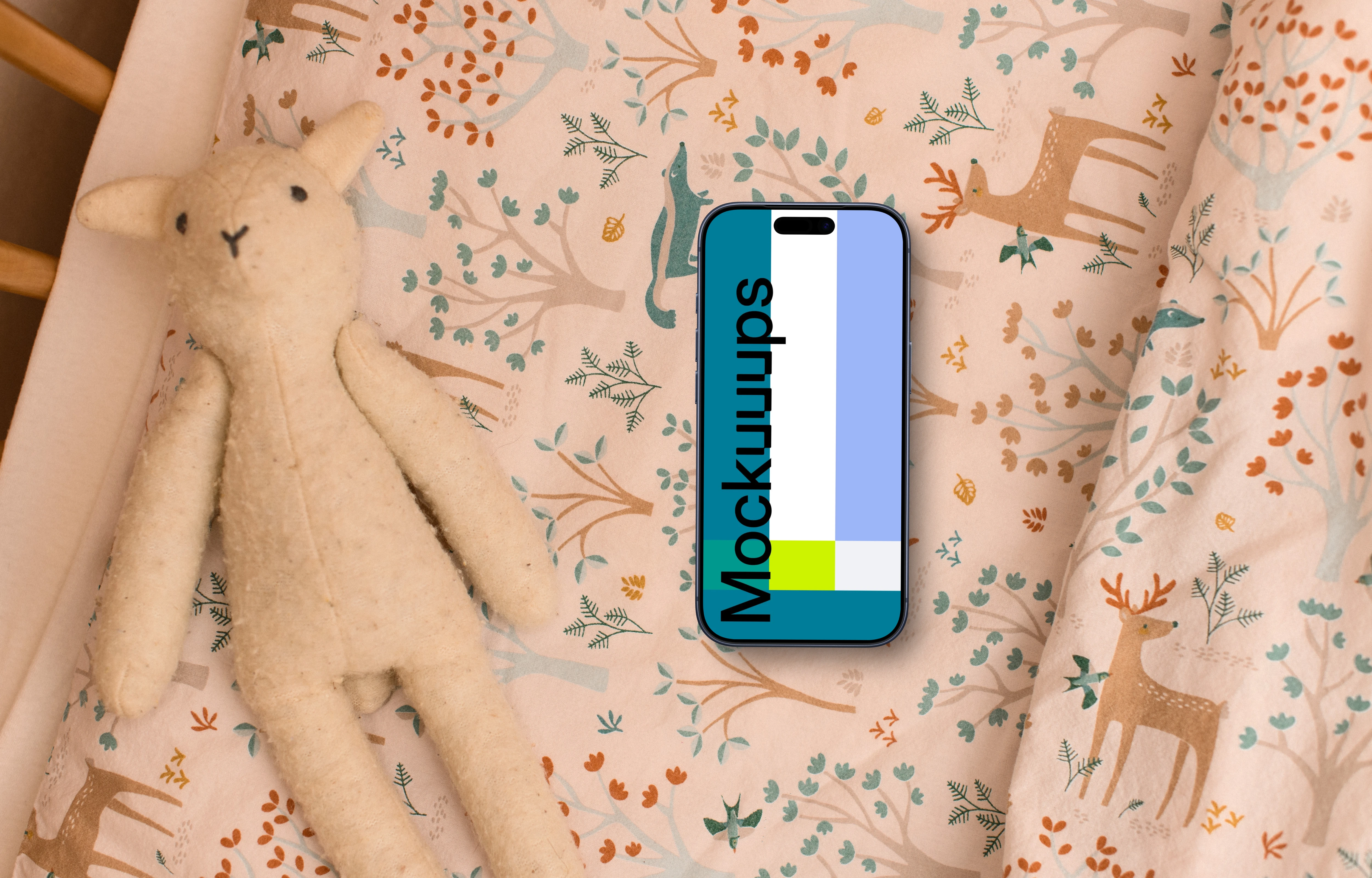 Smartphone mockup with children's toy and patterned bedding