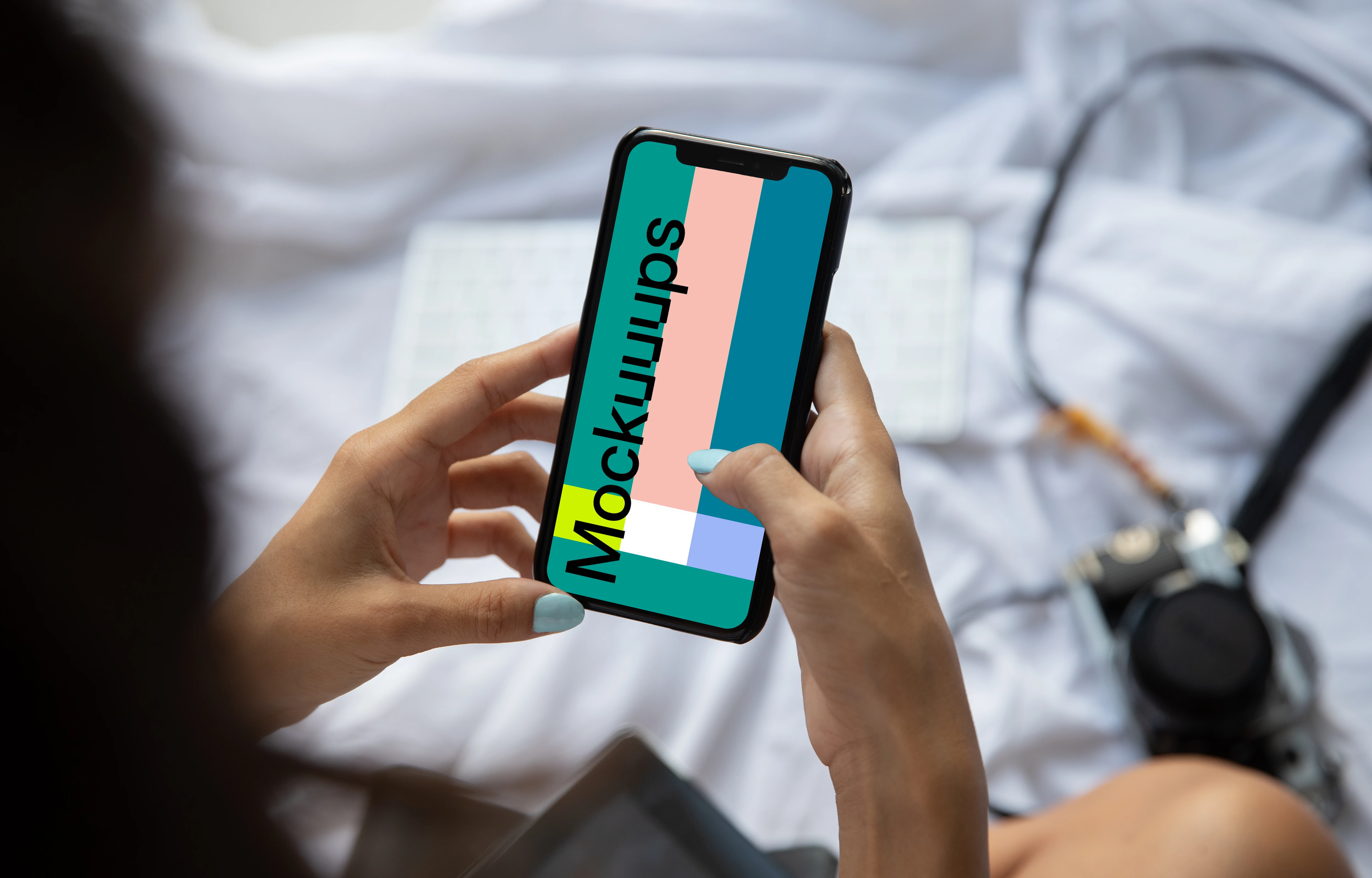 Mockup of lady holding an iPhone in bed