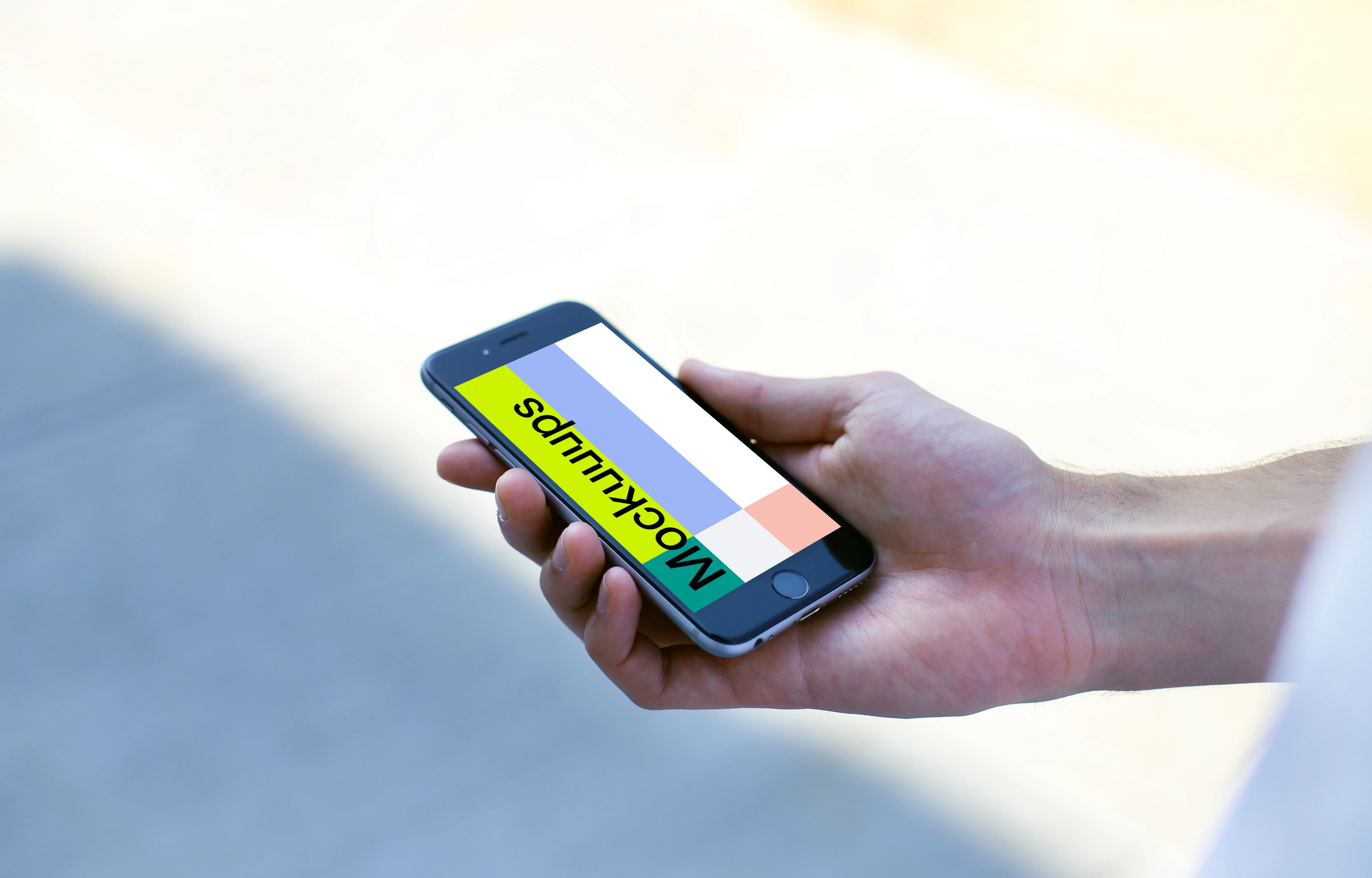 Holding a iPhone 6s mockup on the street