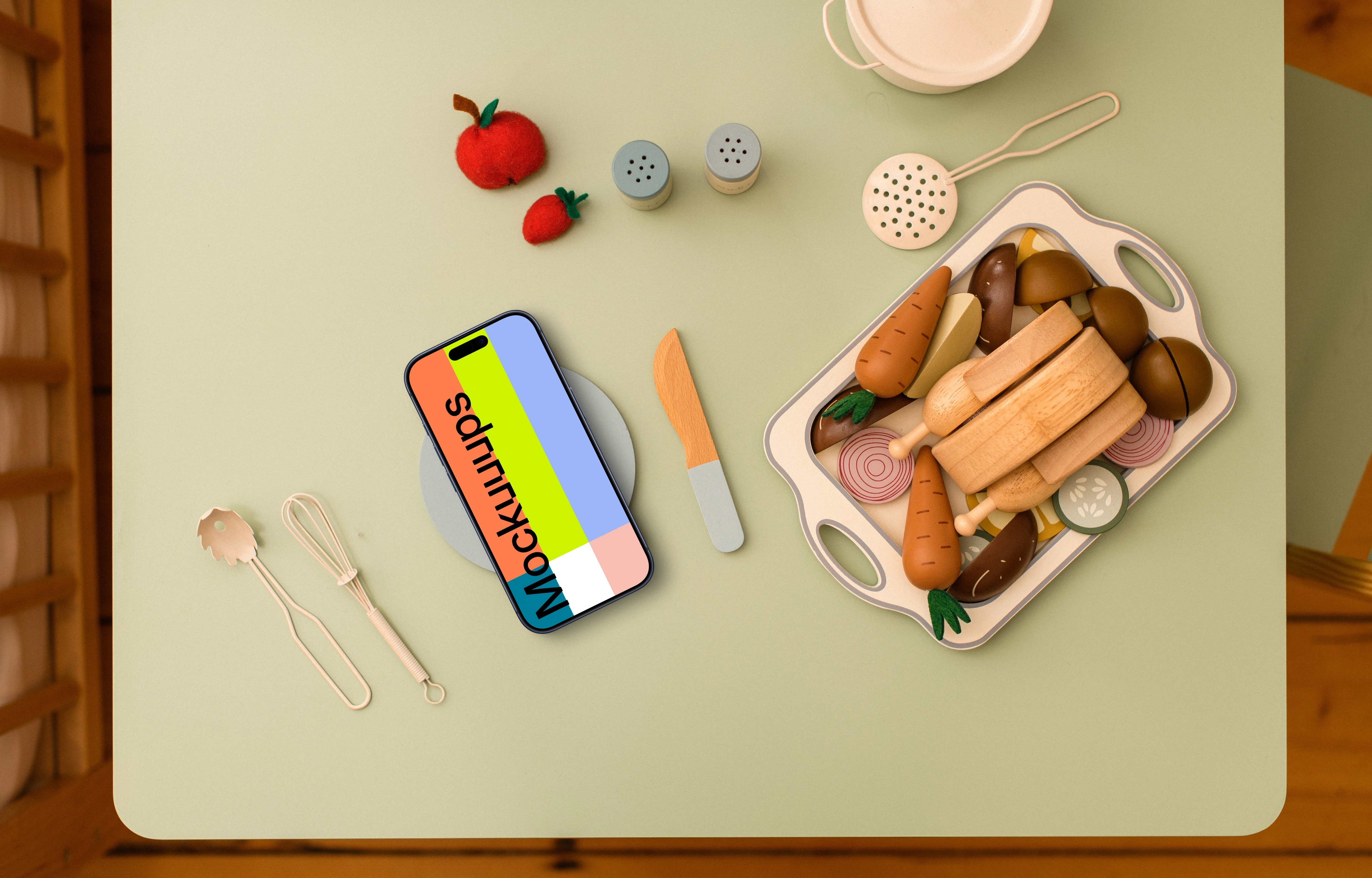 Smartphone mockup with playful wooden toy kitchen accessories